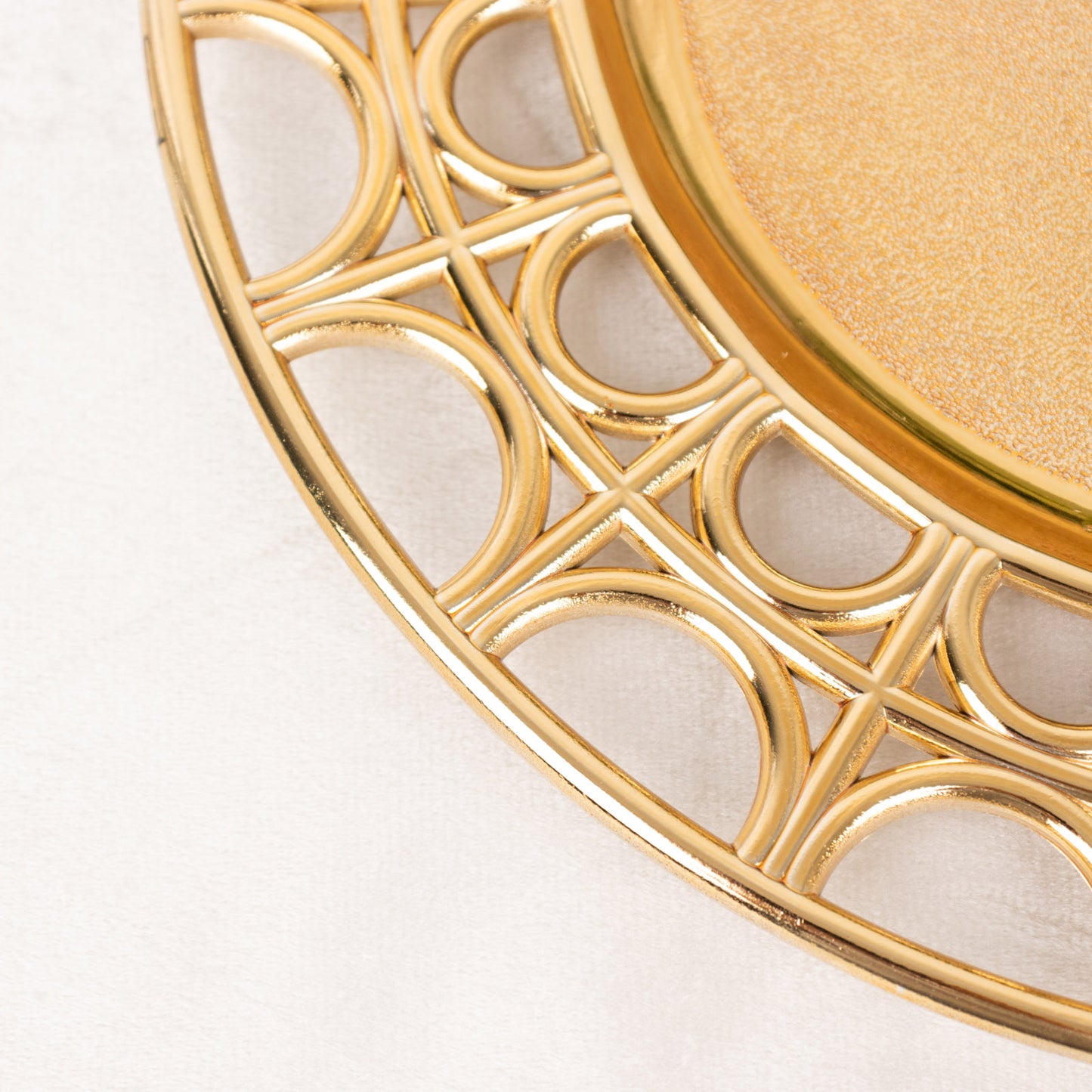 Metallic gold acrylic charger plate with hollow out rim.