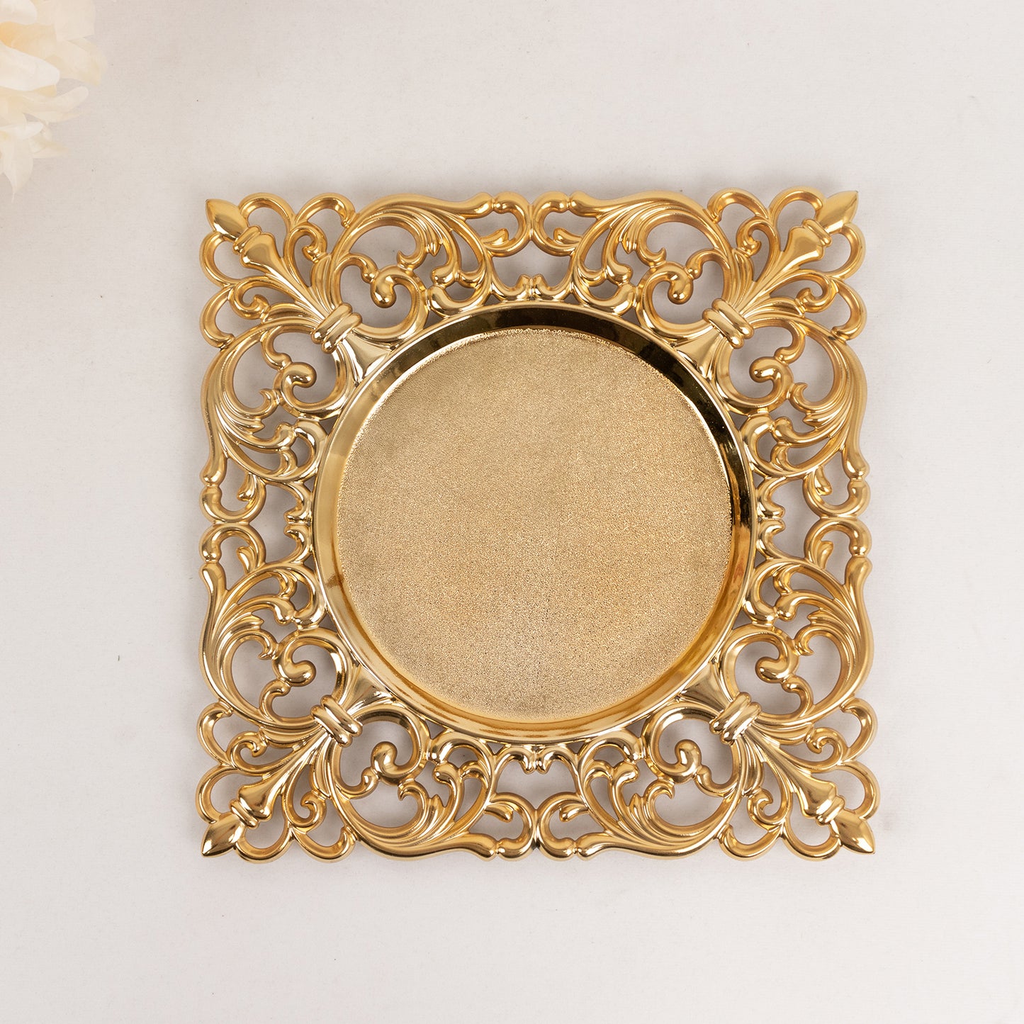 Gold square acrylic charger plate with hollow lace border.