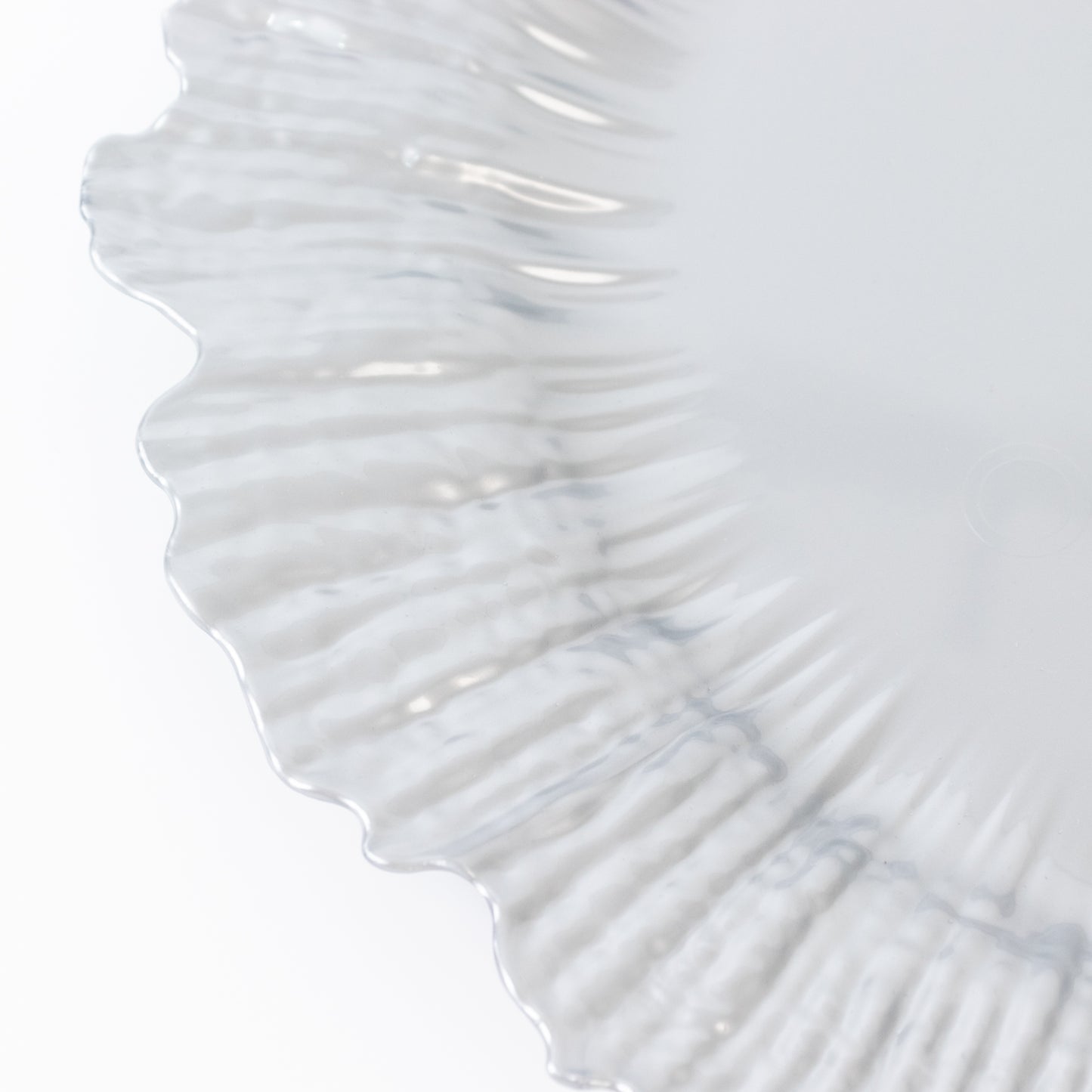 Silver charger plate with a textured rim, ideal for events and catering.