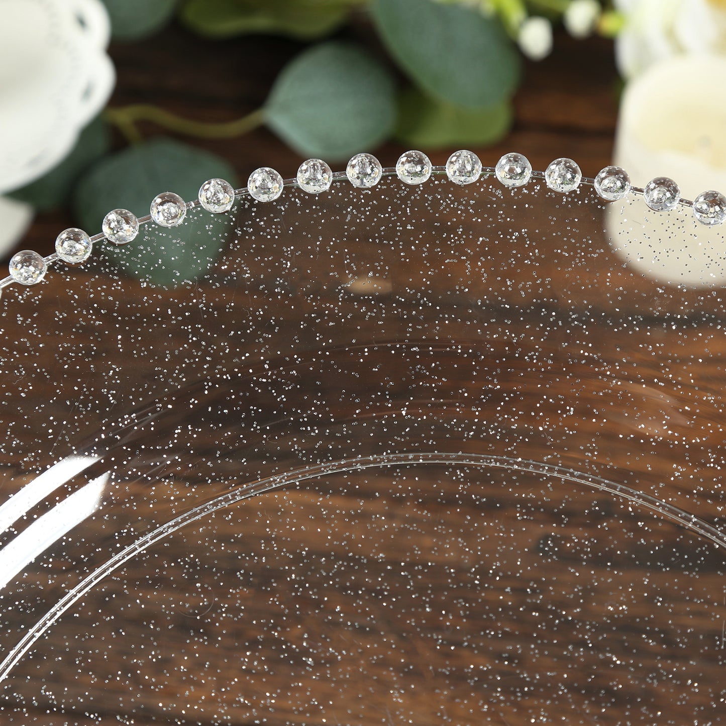 Clear and silver glitter charger plate with beaded rim.