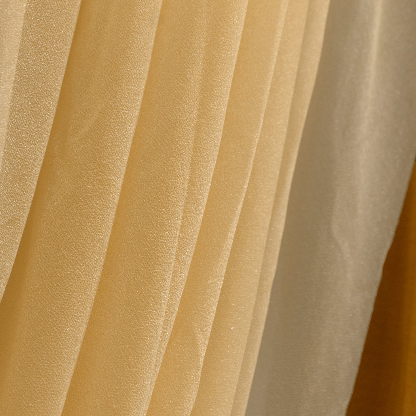 Champagne sheer chiffon backdrop valance drapes with curved swag design.