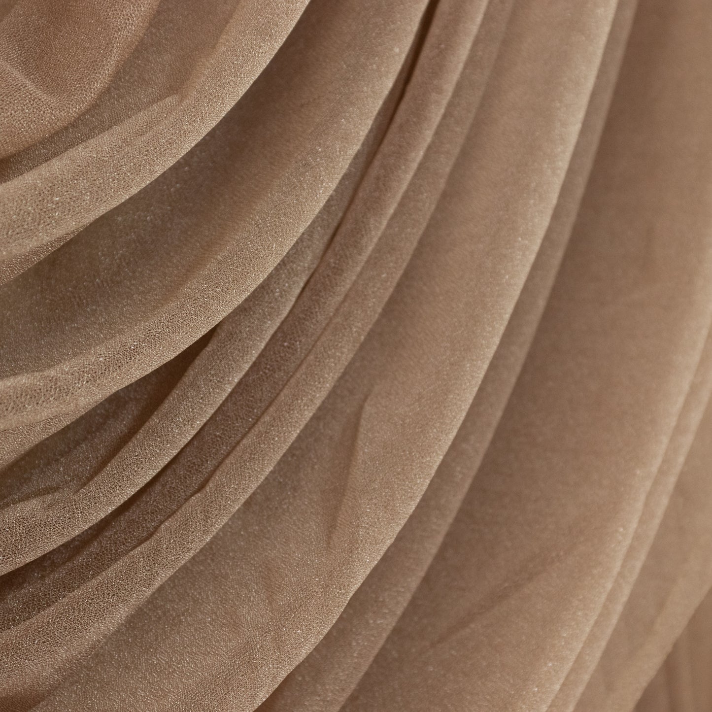 Taupe sheer chiffon backdrop valance drapes with curved swag design.