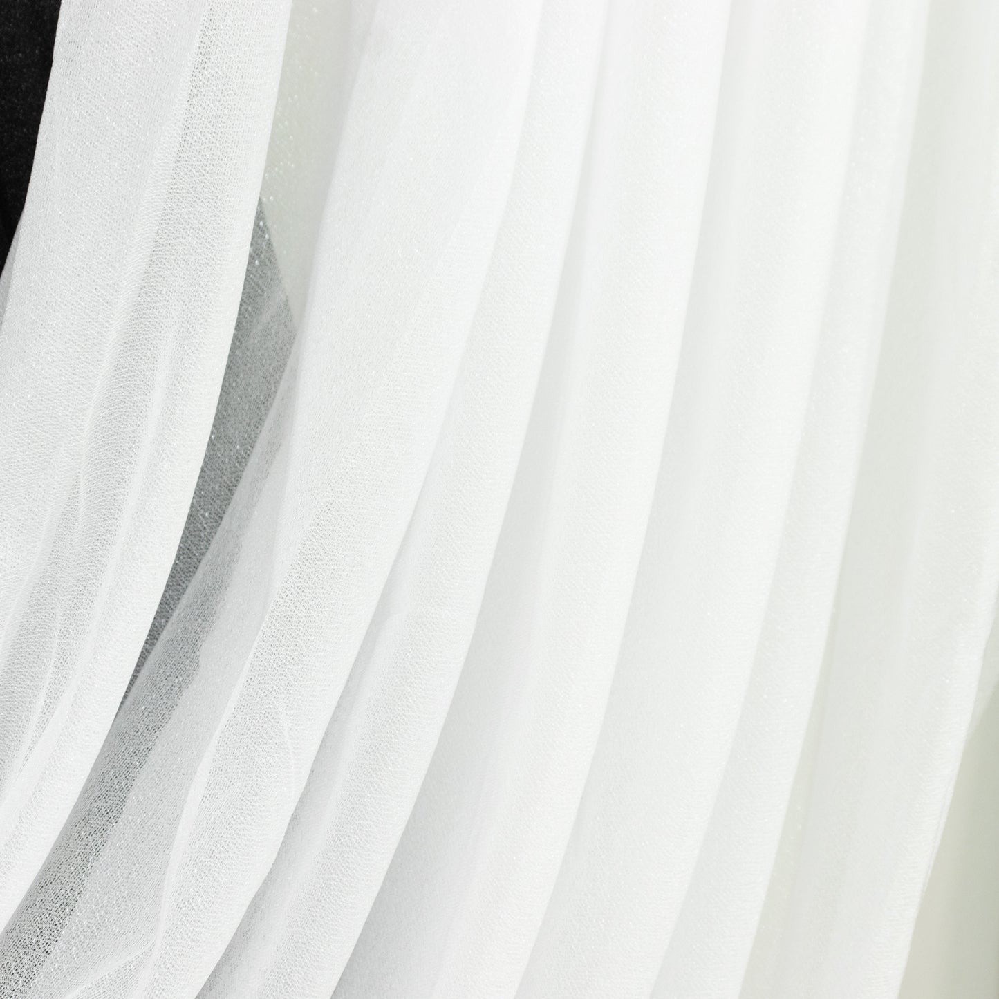 White sheer chiffon backdrop valance drapes with curved swag topper panel.