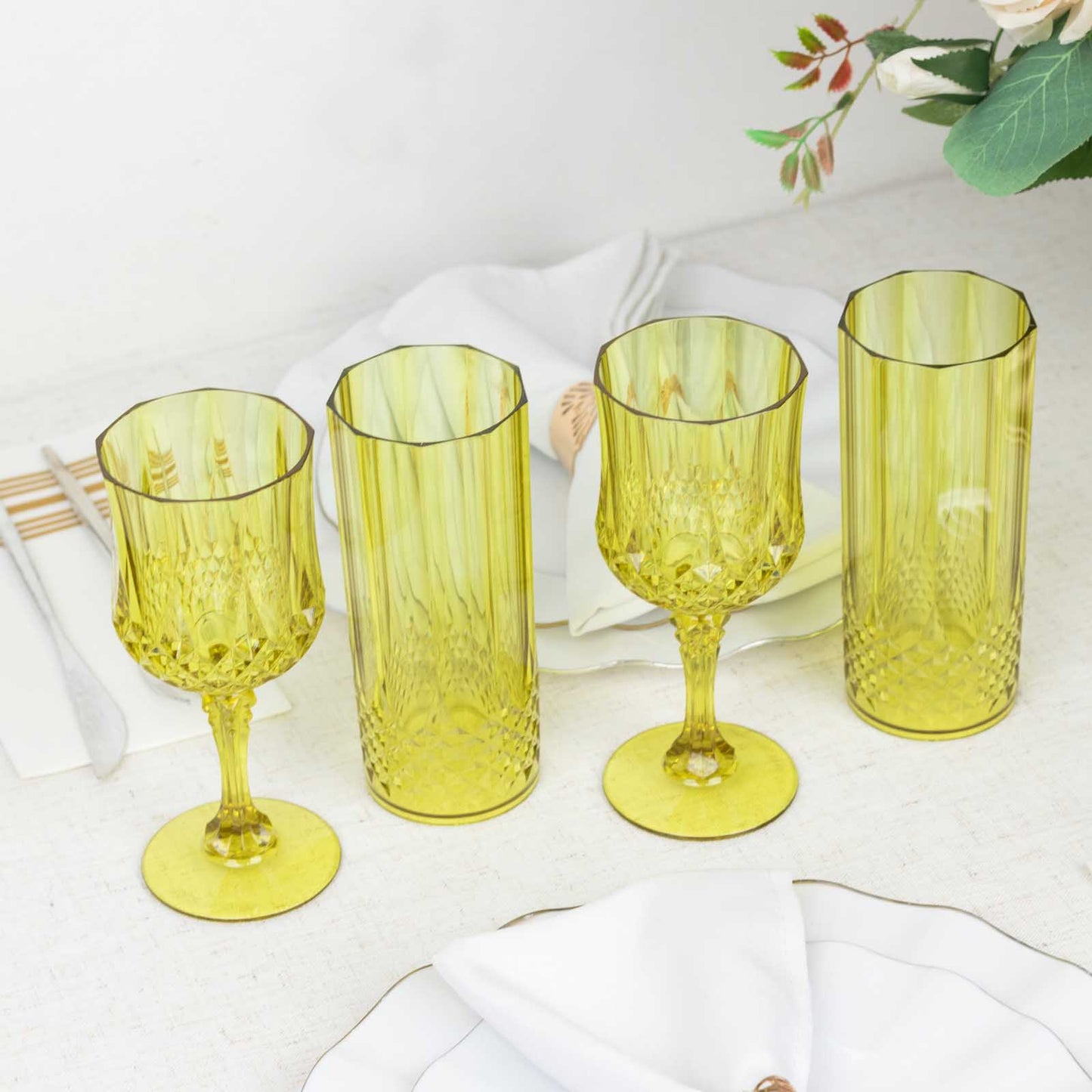 Yellow crystal cut reusable plastic cocktail goblets.