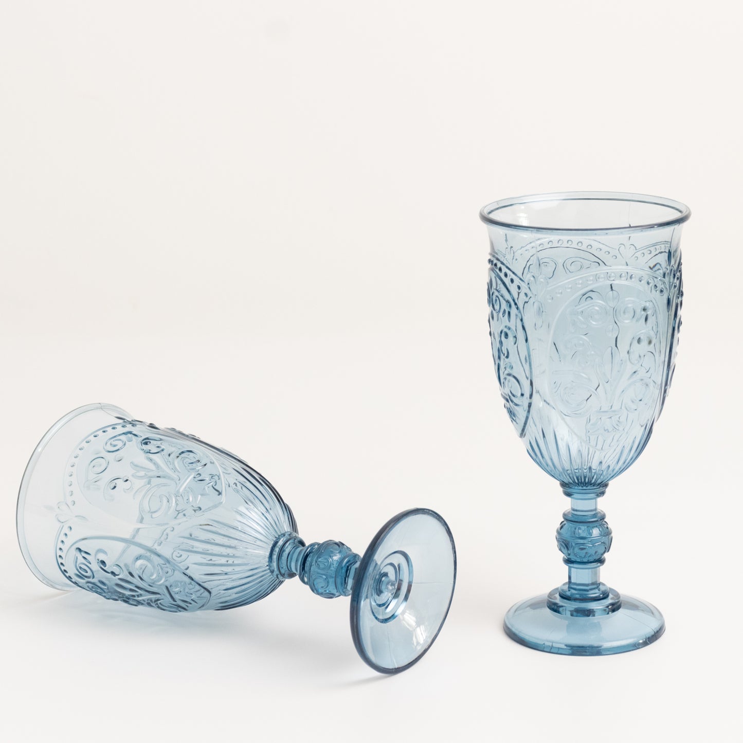 Transparent dusty blue vintage wine glasses with retro embossed design.