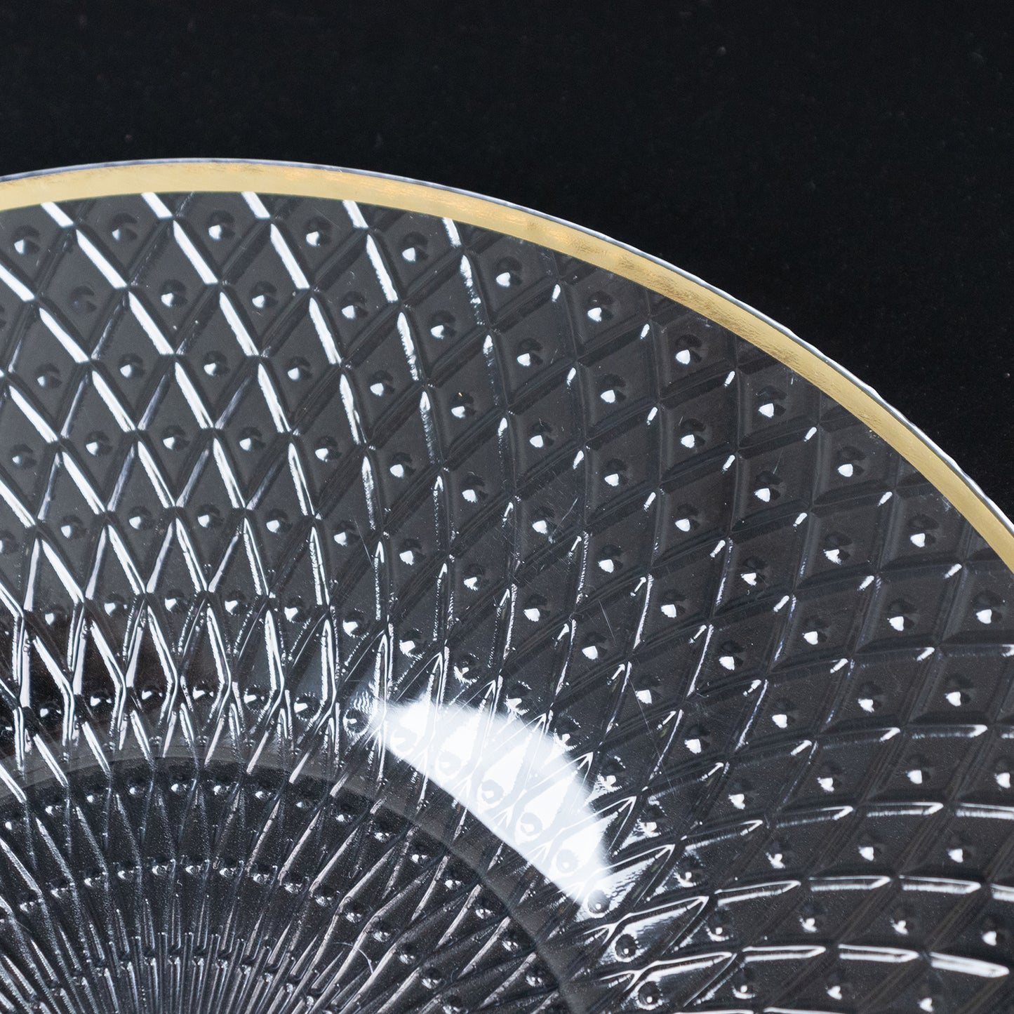Clear plastic dessert plate with gold rim and diamond-cut pattern.