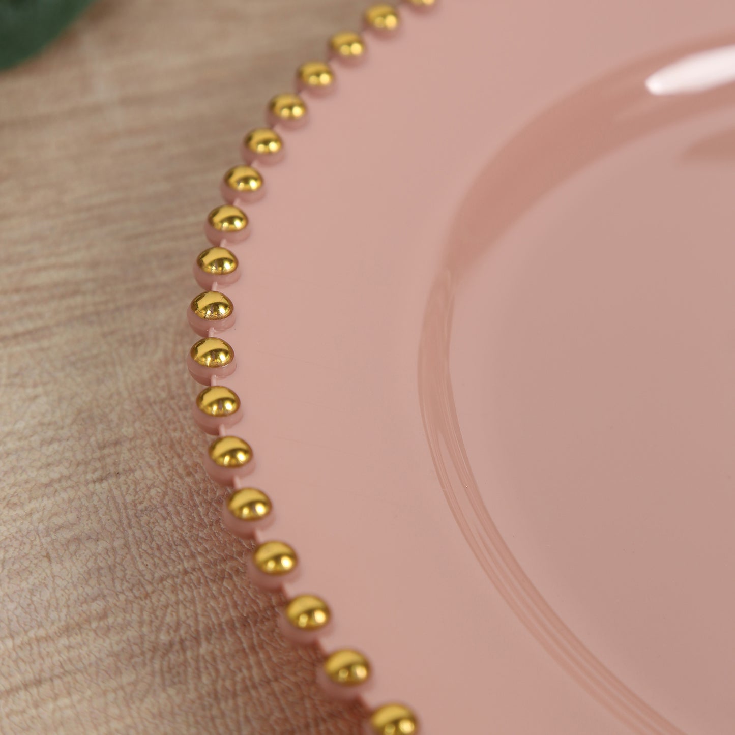 Dusty rose disposable dinner plate with gold beaded rim.