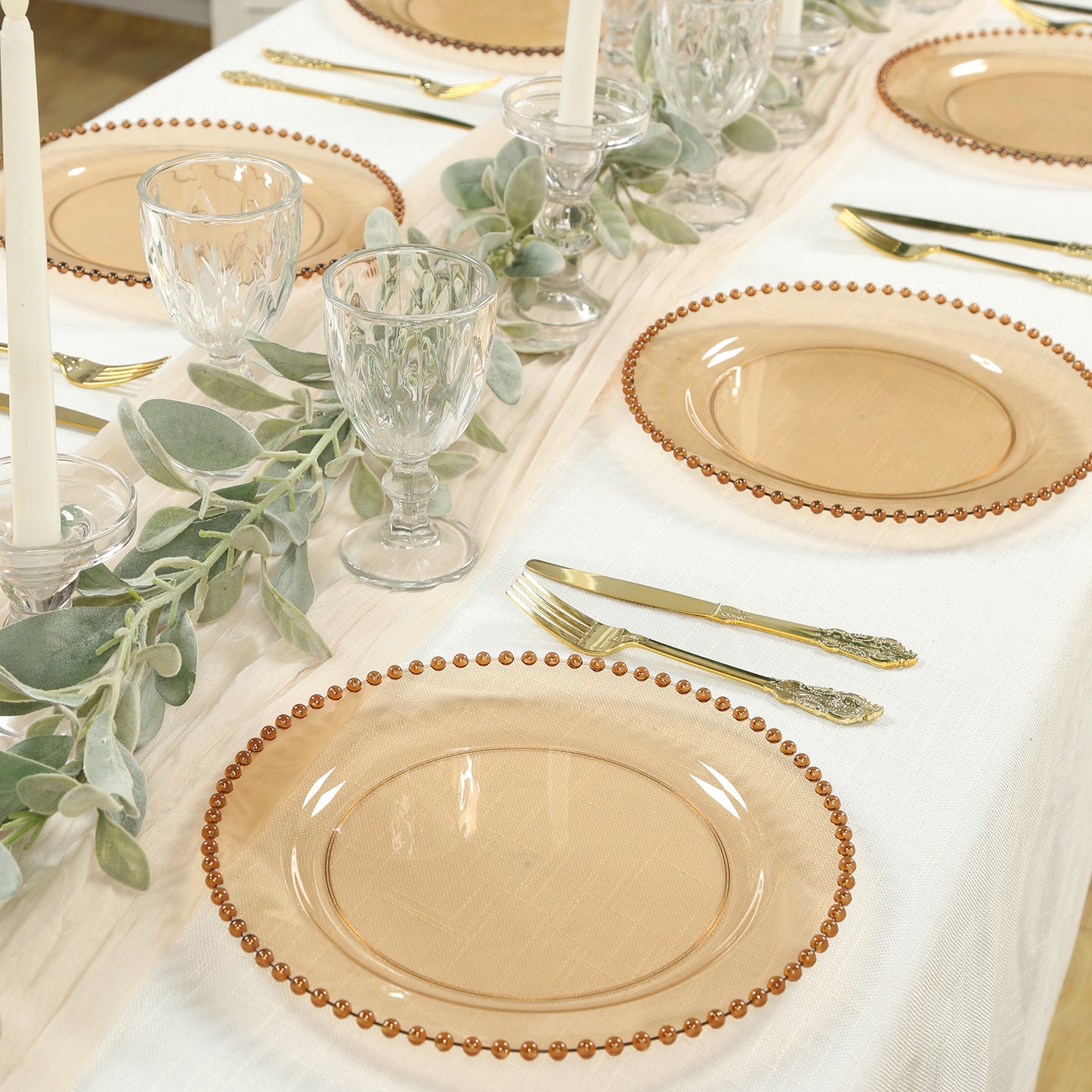 Amber gold round dinner plates with beaded rim on a festive table setting.