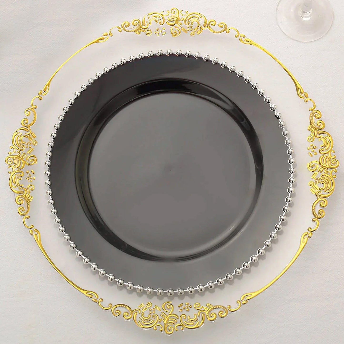 Black disposable dinner plate with silver beaded rim for festive occasions.