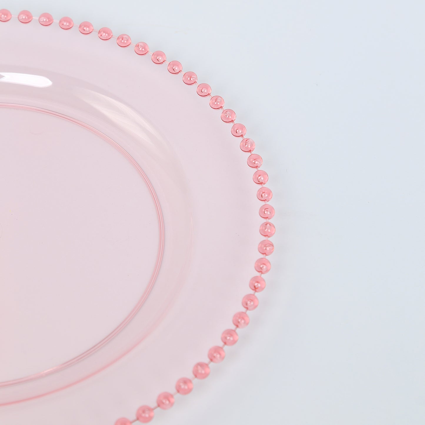 Transparent blush round dinner plate with beaded rim.