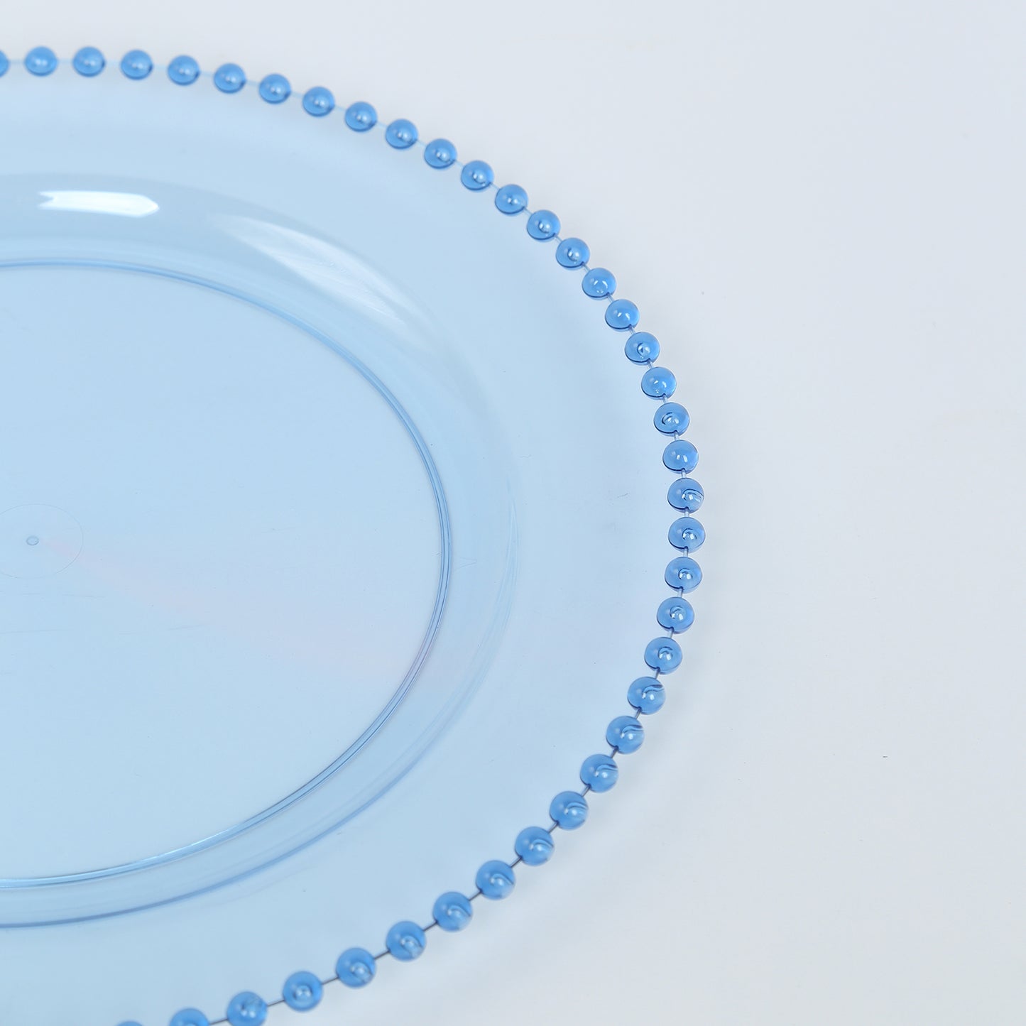 Transparent dusty blue round dinner plate with beaded rim.