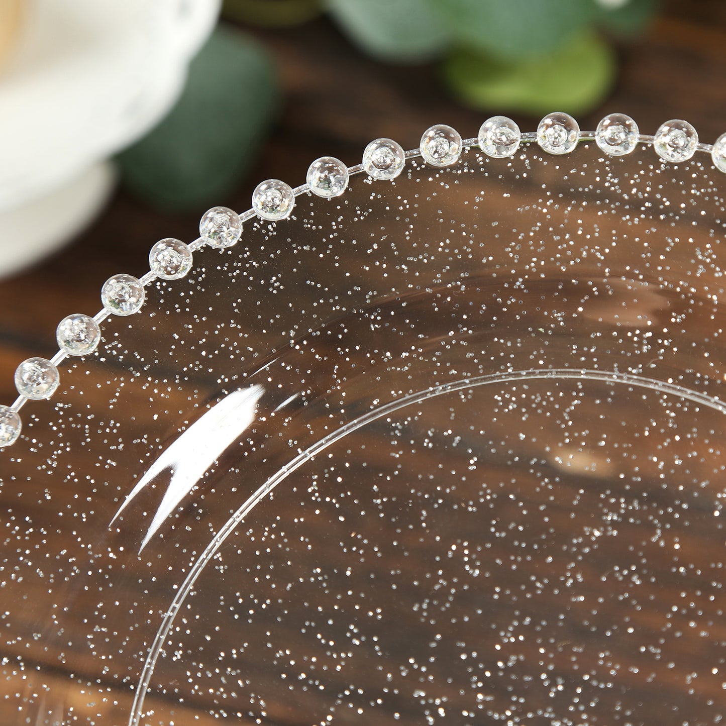 Clear silver glittered plastic dessert plate with beaded rim.