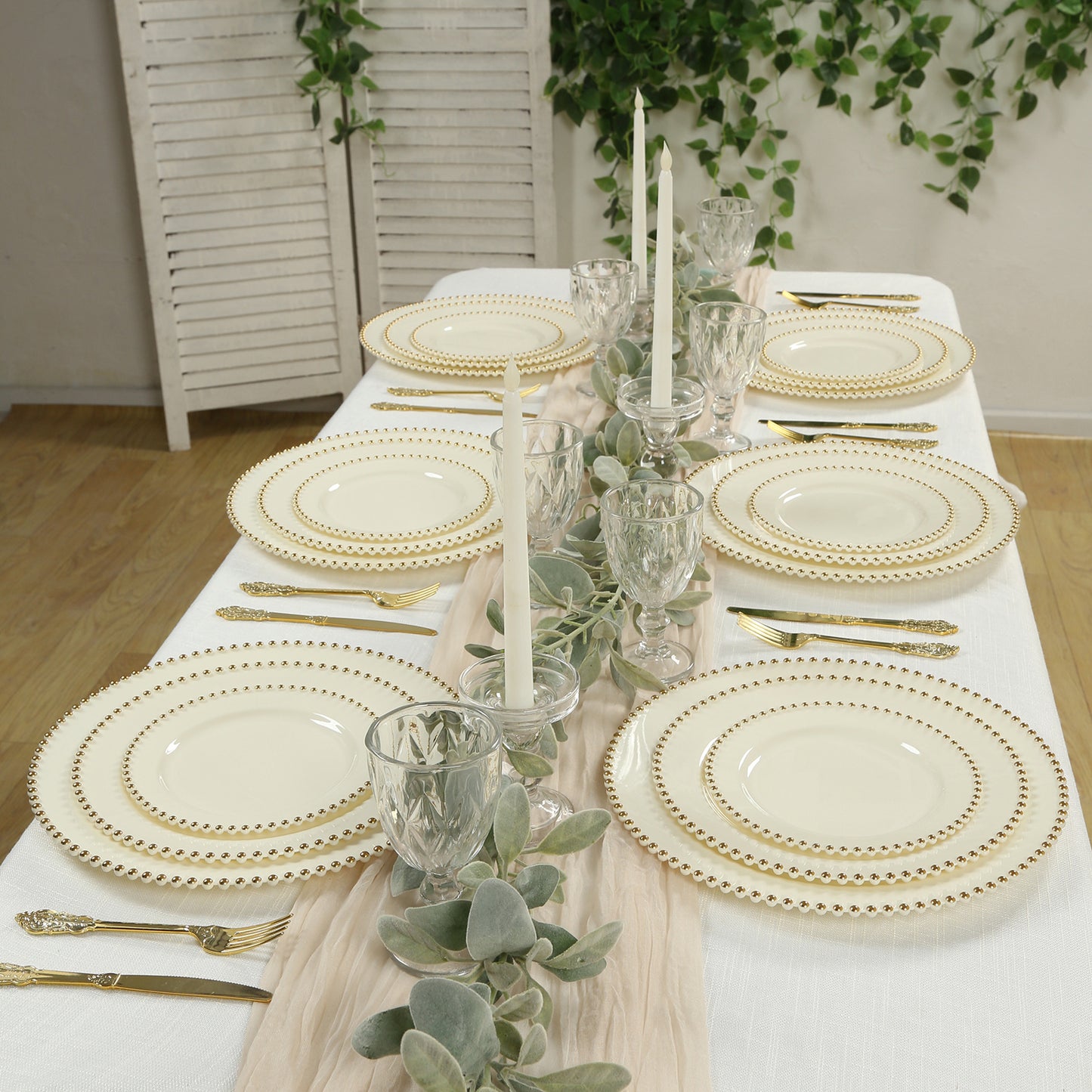 Ivory plastic dessert plates with gold beaded rim on a festive table setting.