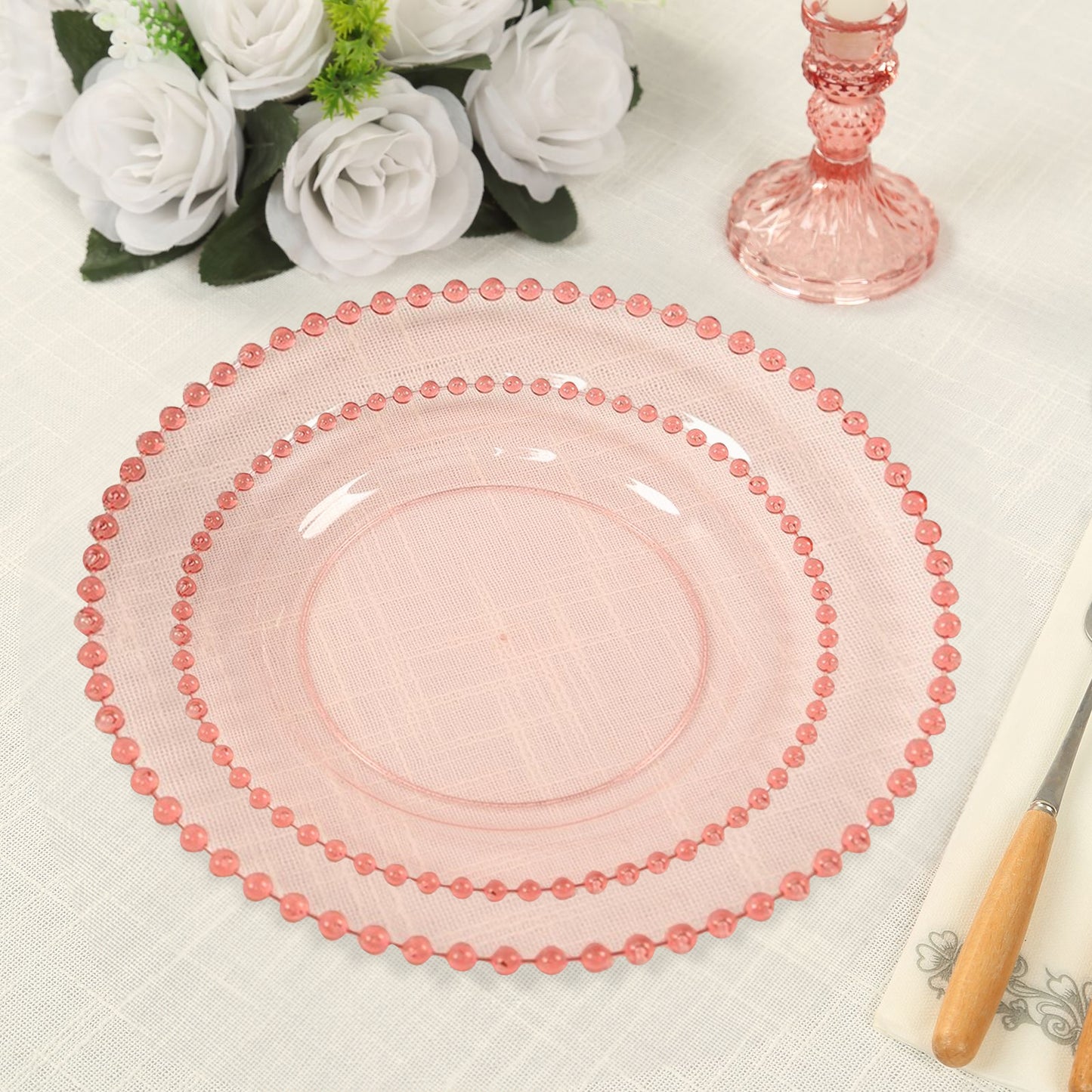 Transparent blush plastic dessert plates with gold beaded rim, perfect for parties.