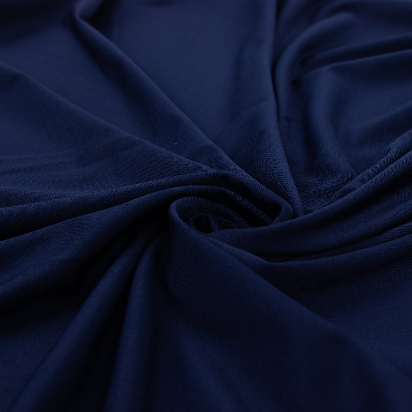 Navy blue 4-way stretch spandex fabric roll, perfect for DIY crafts.