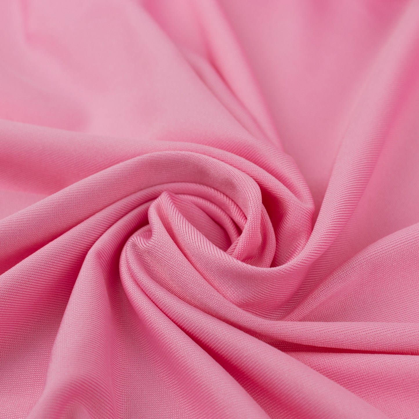 Pink spandex 4-way stretch fabric roll, perfect for DIY crafts.