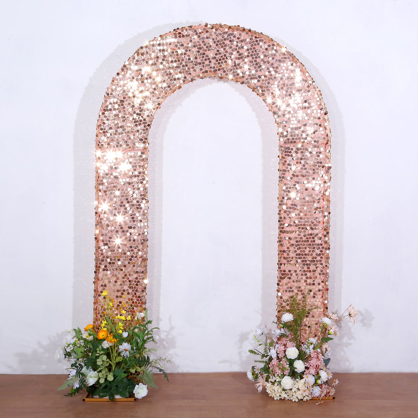 8ft rose gold sequin wedding arch backdrop with floral arrangements.