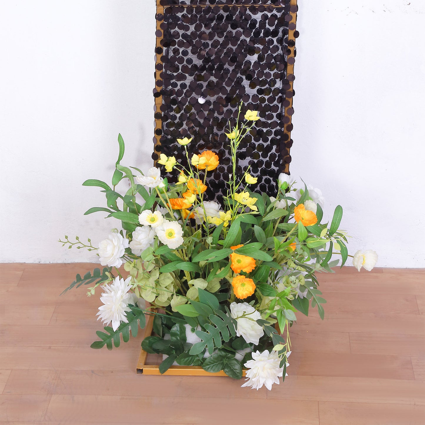 Black double-sided sequin wedding arch cover with floral arrangement.