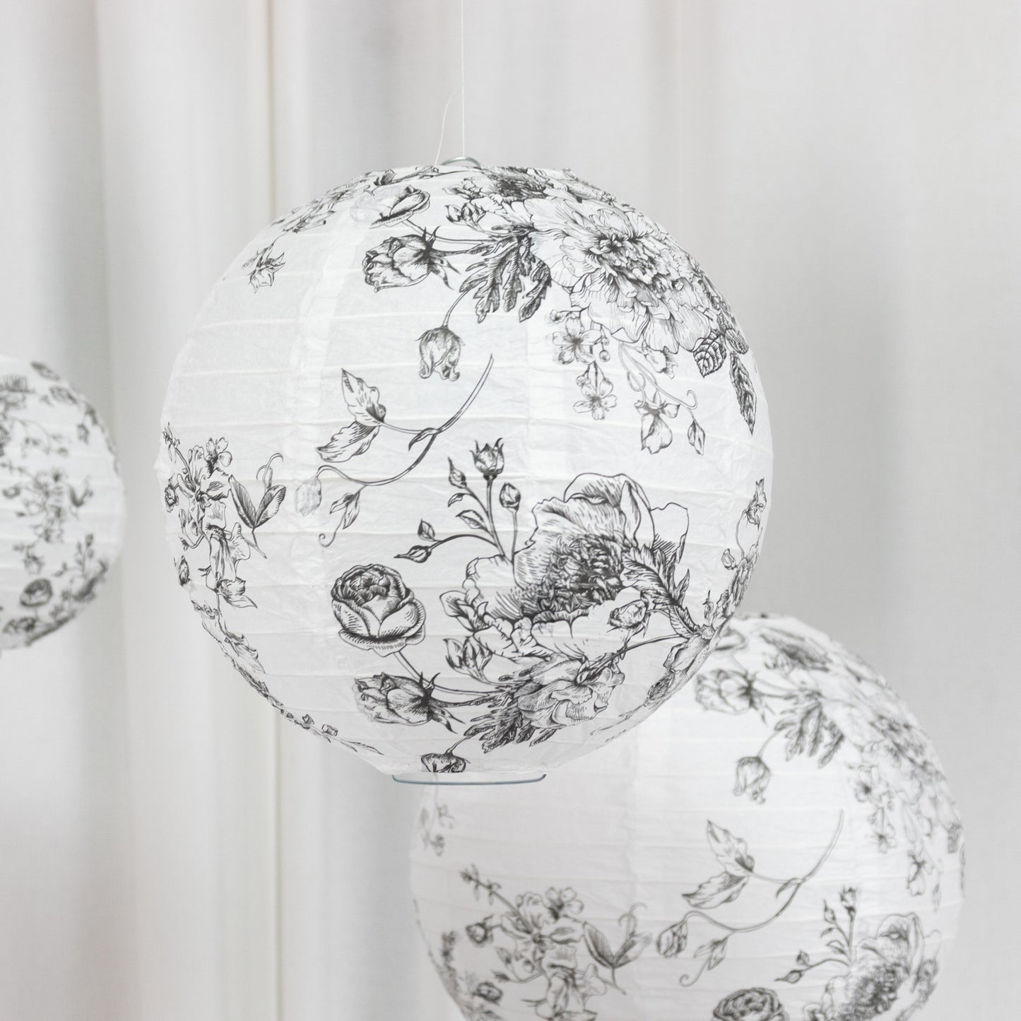 White paper lanterns with black floral pattern, set of 8 hanging decorations.