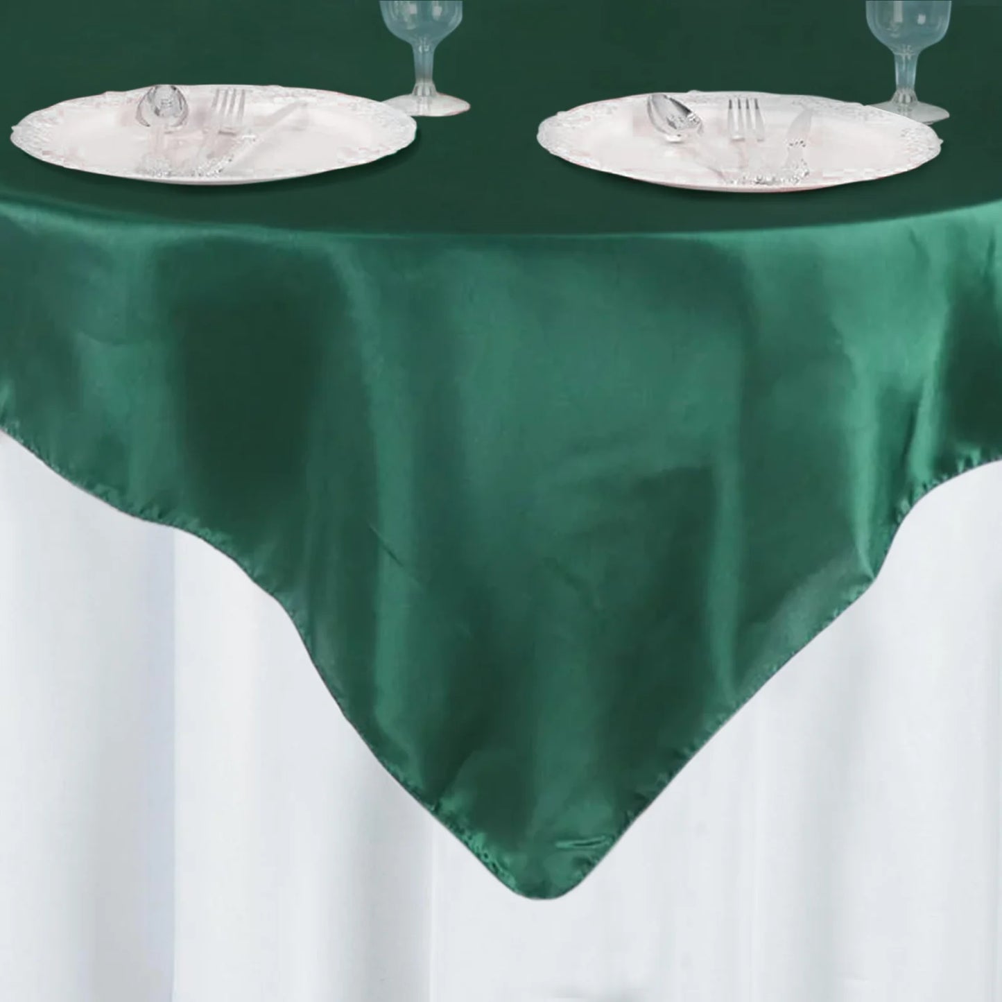 60"x60" Hunter Emerald Green Satin Table Overlay on a white table.