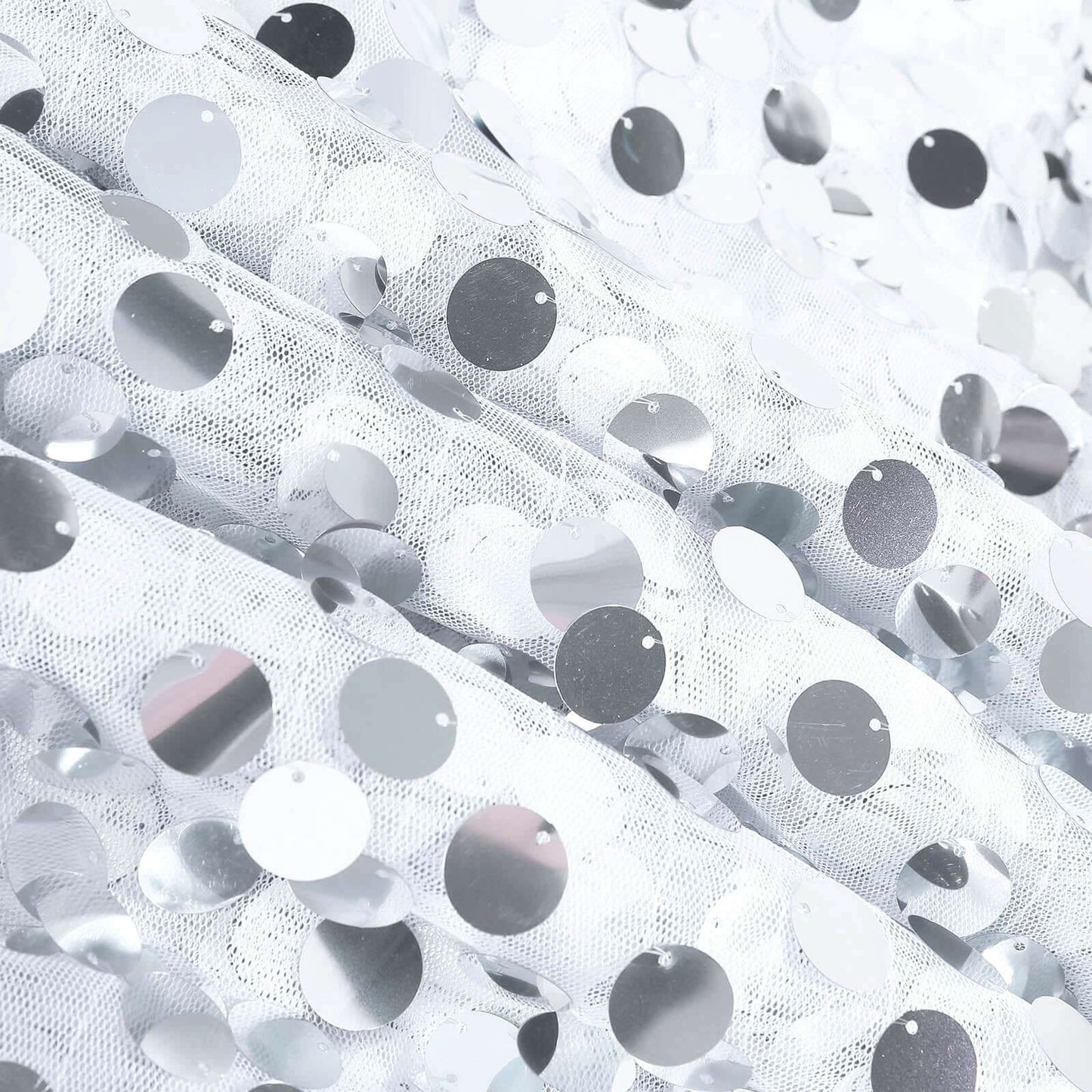 White sequin table overlay with shimmering circular accents. #whtbkgd