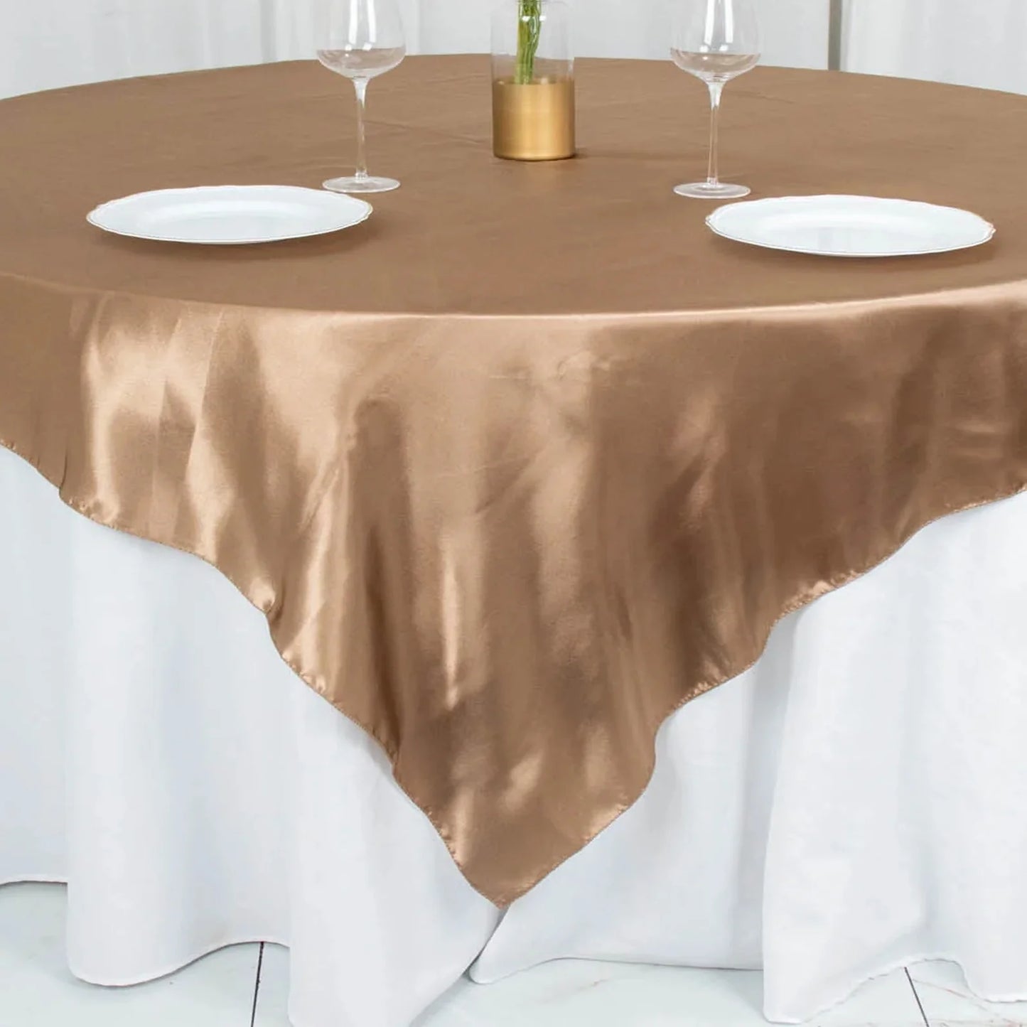 Taupe smooth satin square table overlay on a round table.