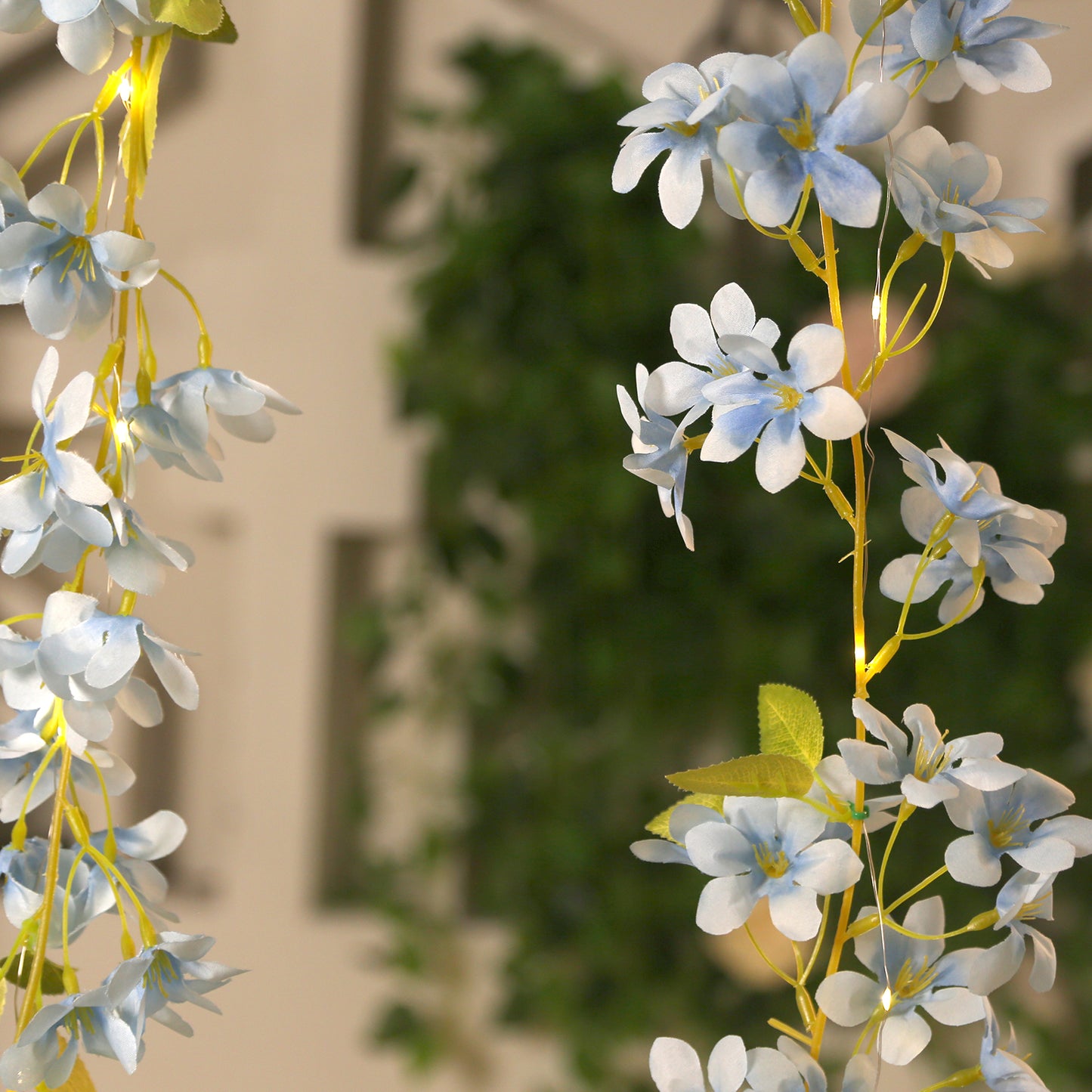 Blue jasmine silk flower garland with warm white LED fairy lights.