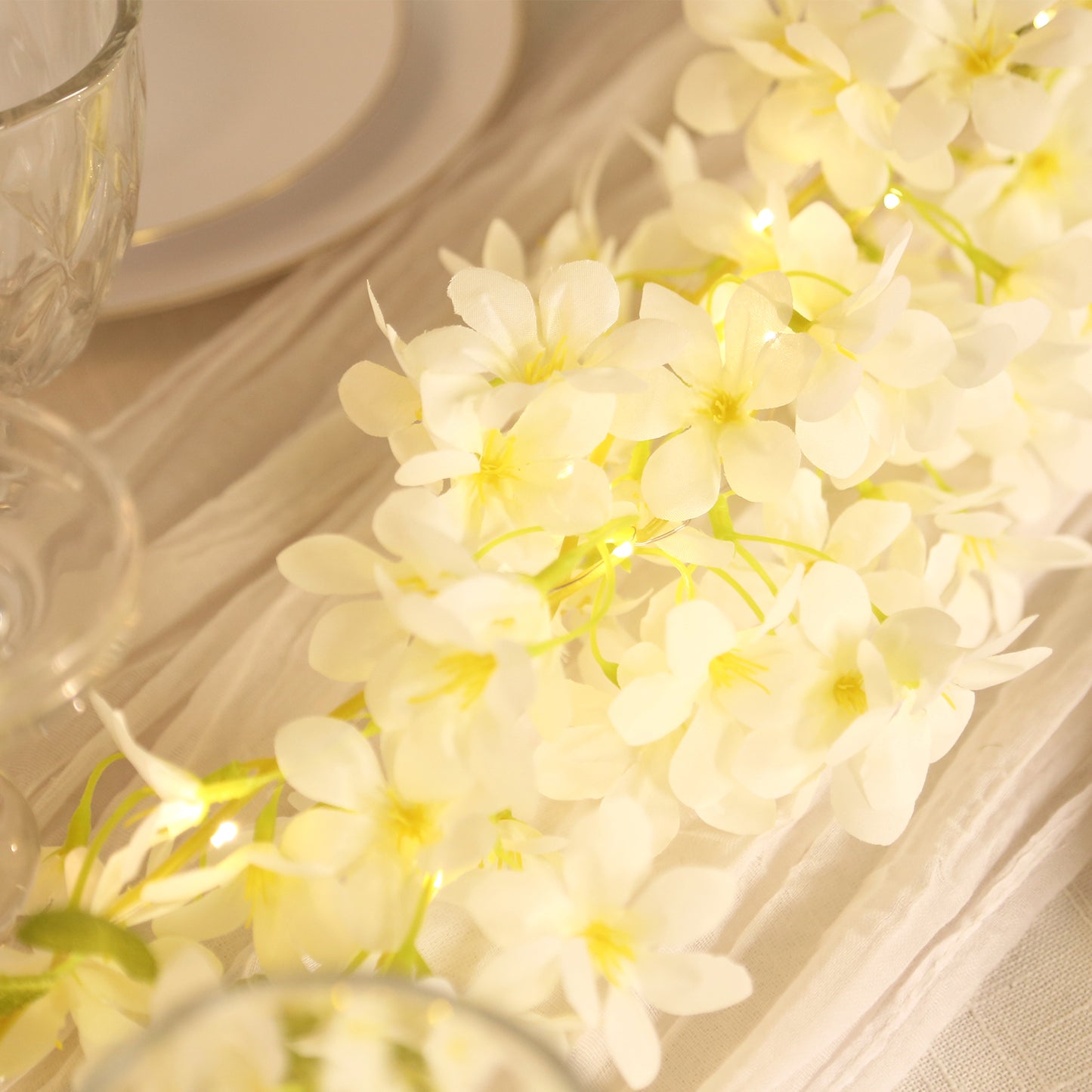 White Jasmine silk flower garland with warm white LED lights.