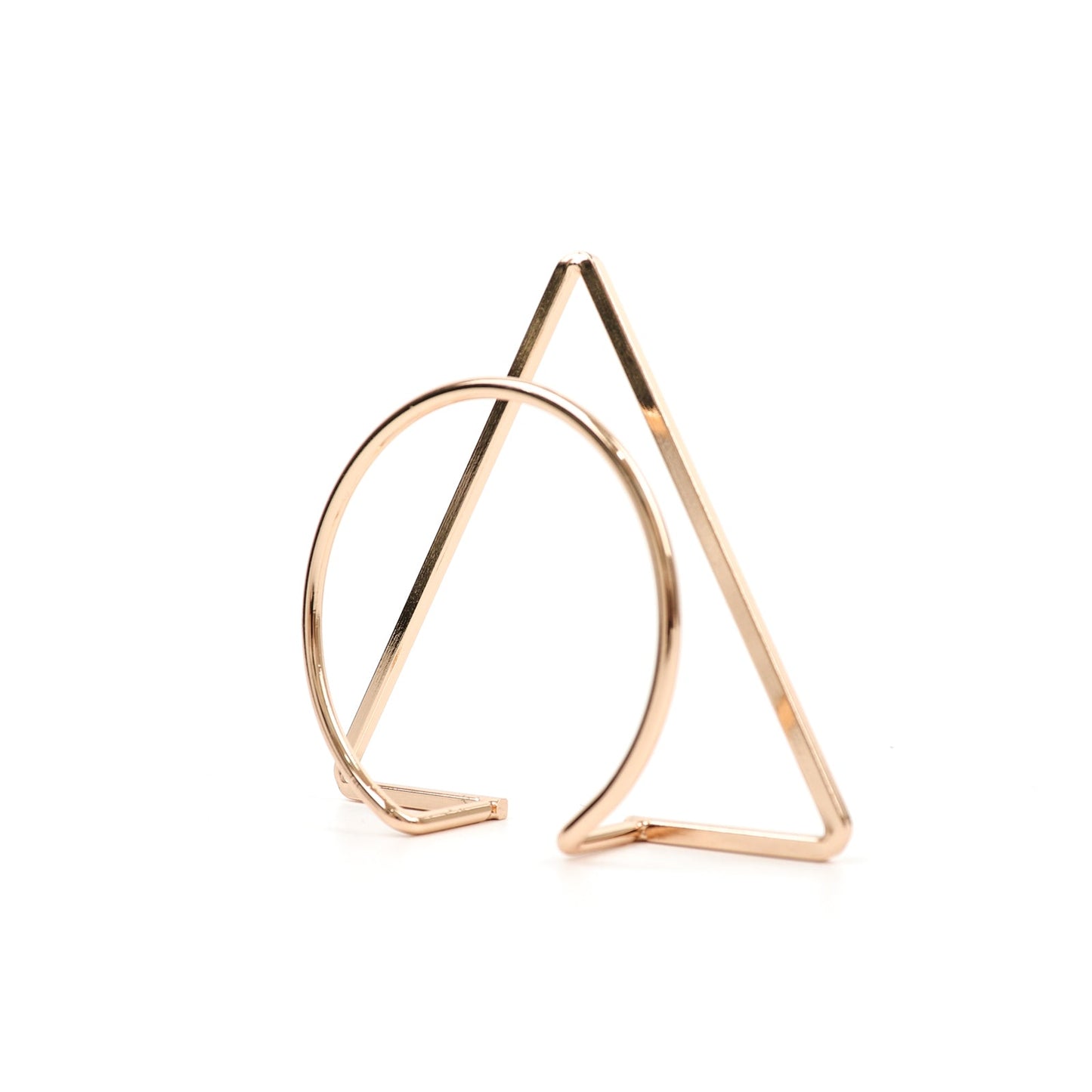 Gold geometric metal napkin rings in a modern design.