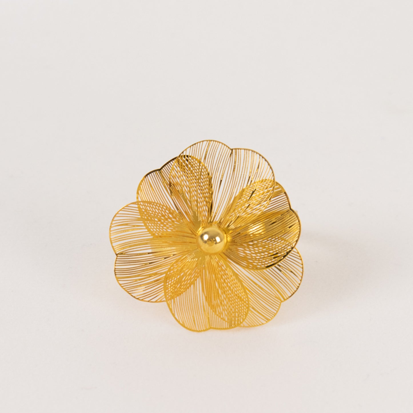 Gold metal jasmine flower napkin holder with pearl center.