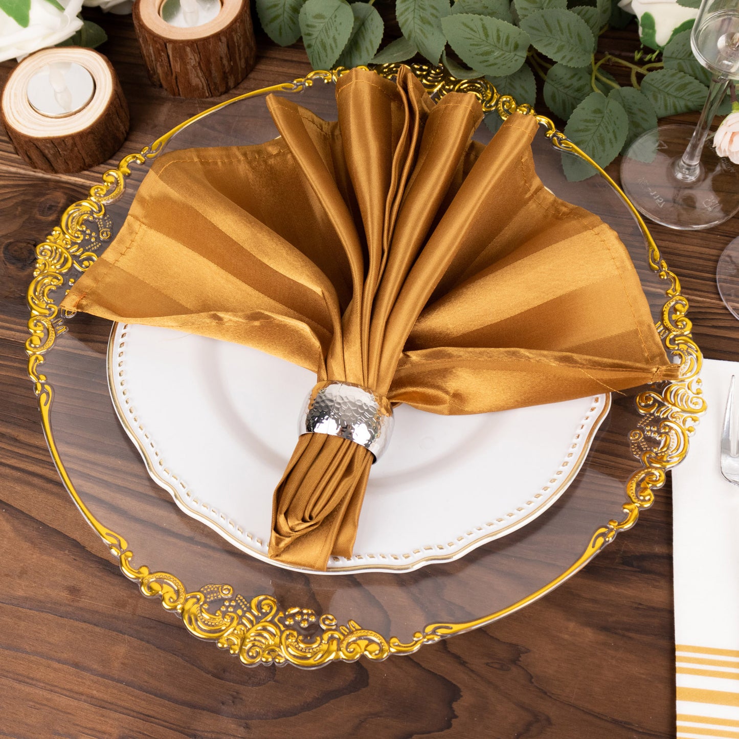Gold striped satin linen napkin on an elegant plate setting.