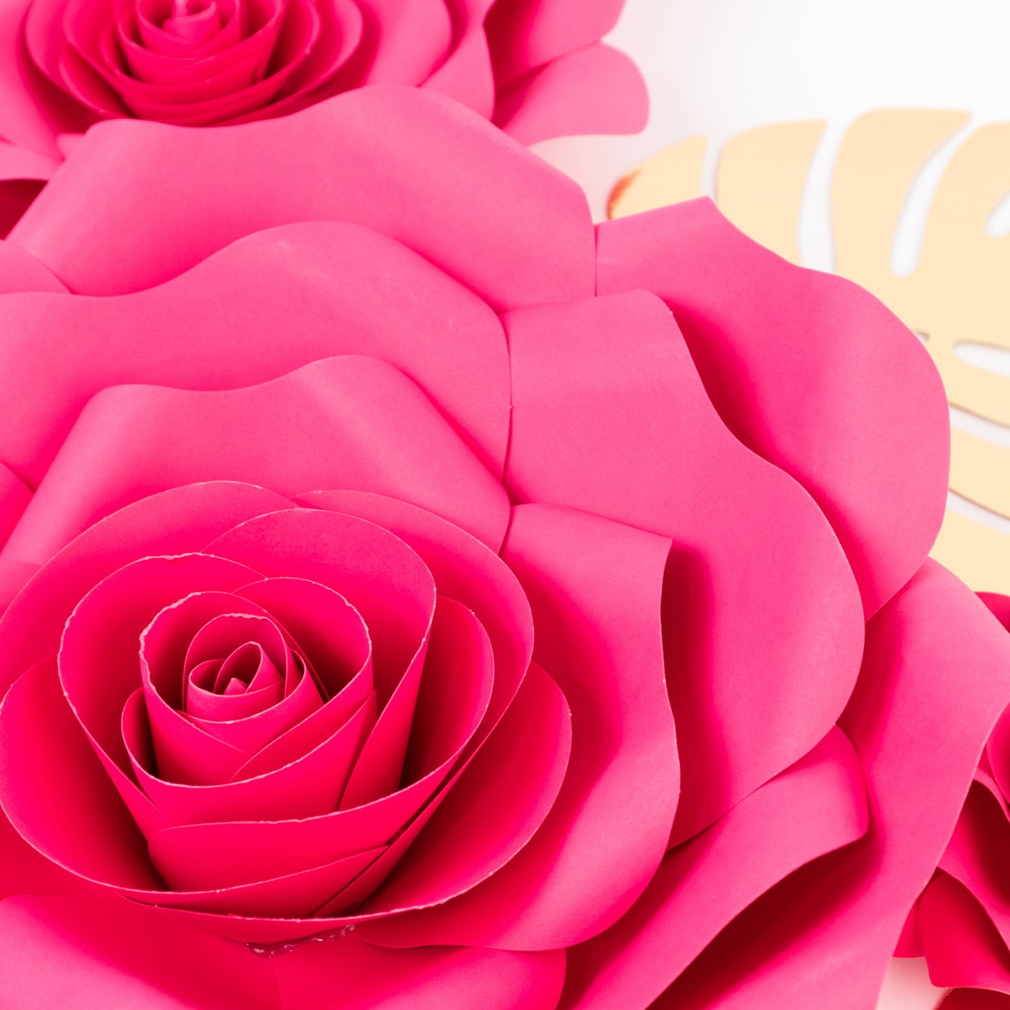 Fuchsia 3D rose paper flowers with gold tropical palm leaves backdrop decor.