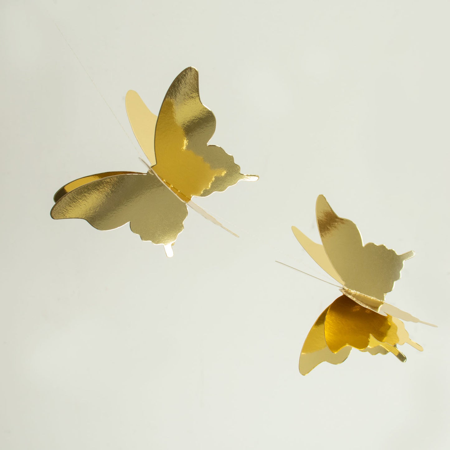 Gold 3D paper butterfly garland streamers for party decorations.