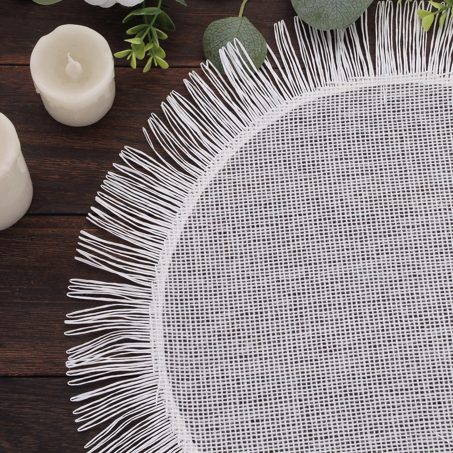 White rustic farmhouse burlap tassel table mat with jute fringe edge.