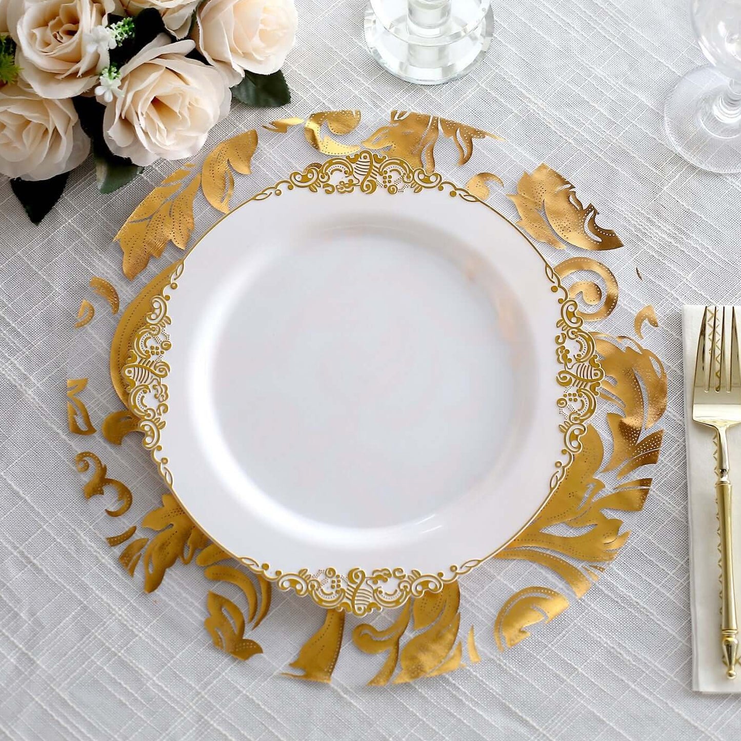 Metallic gold round placemat with floral swirl design on a table setting.
