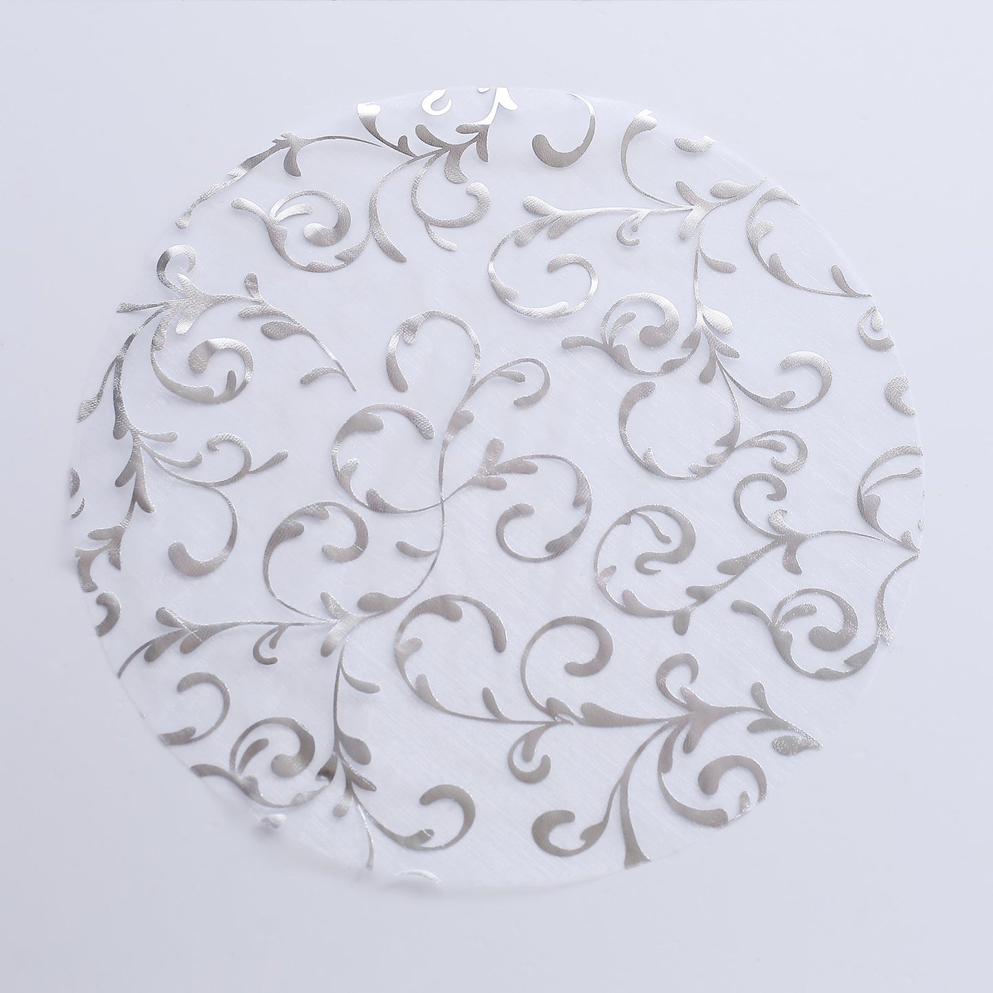 Metallic silver sheer organza placemat with embossed foil flower design.