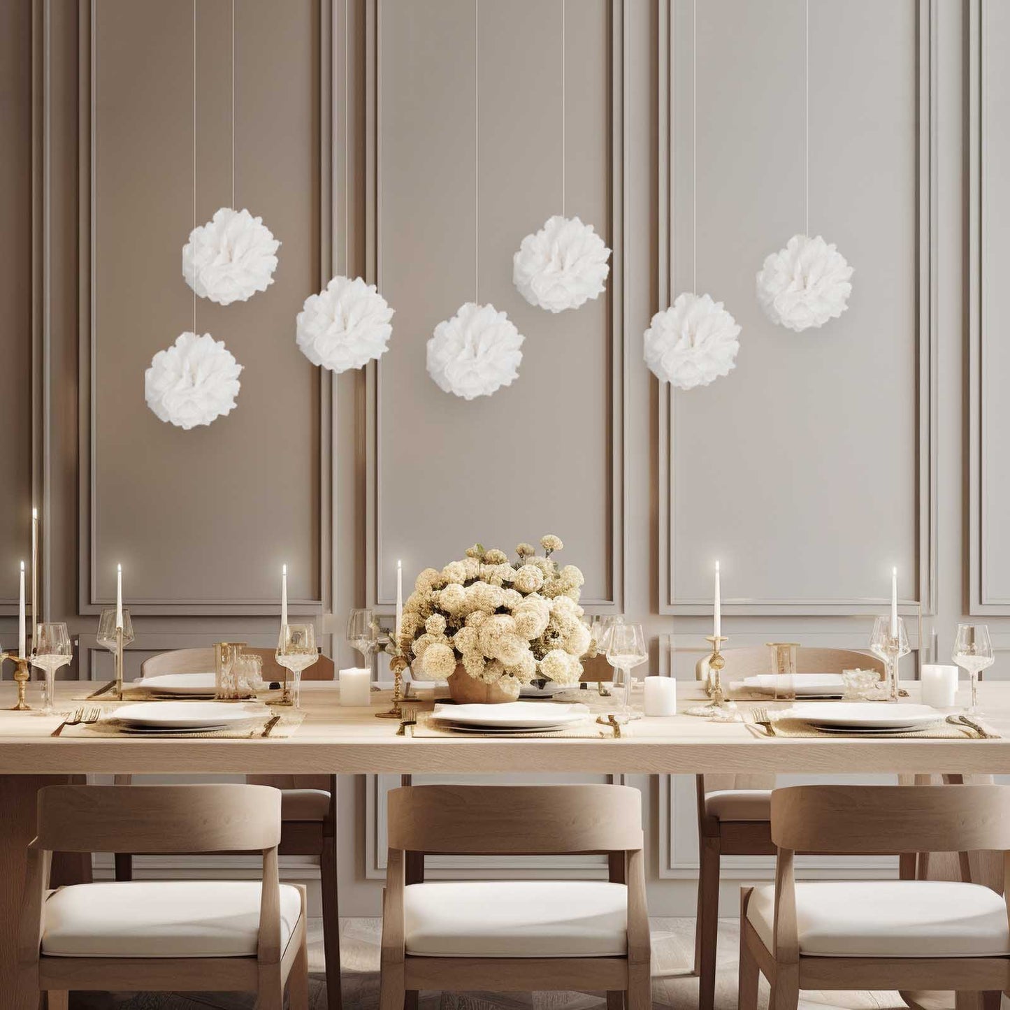 White tissue paper pom poms hanging decor in an elegant dining setting.