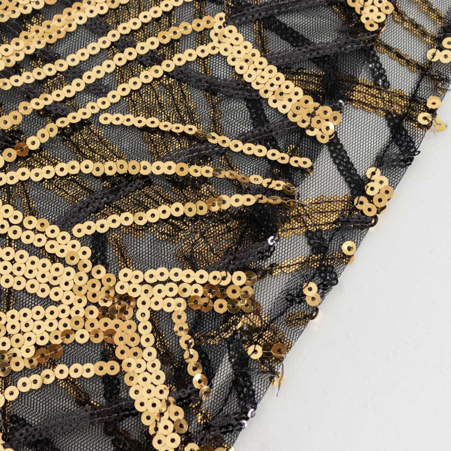 Black wave mesh cylinder pedestal stand cover with embroidered gold sequins.