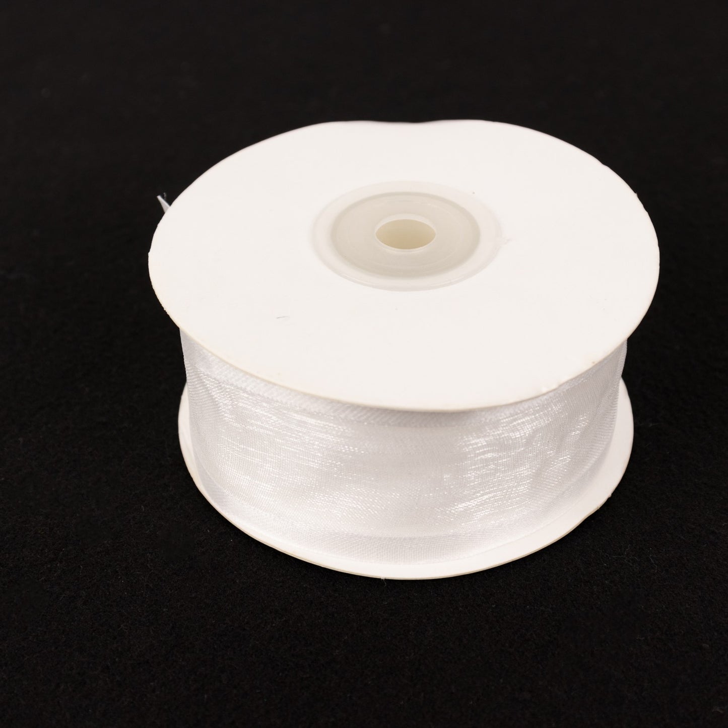 White organza ribbon with satin edges, 25 yards on a spool.