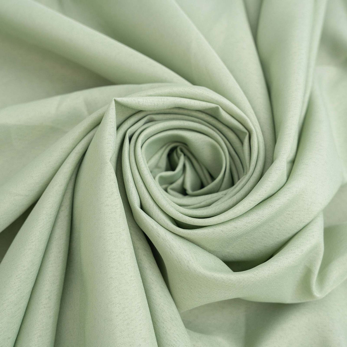 Sage green polyester fabric, ideal for chair covers and decorations.