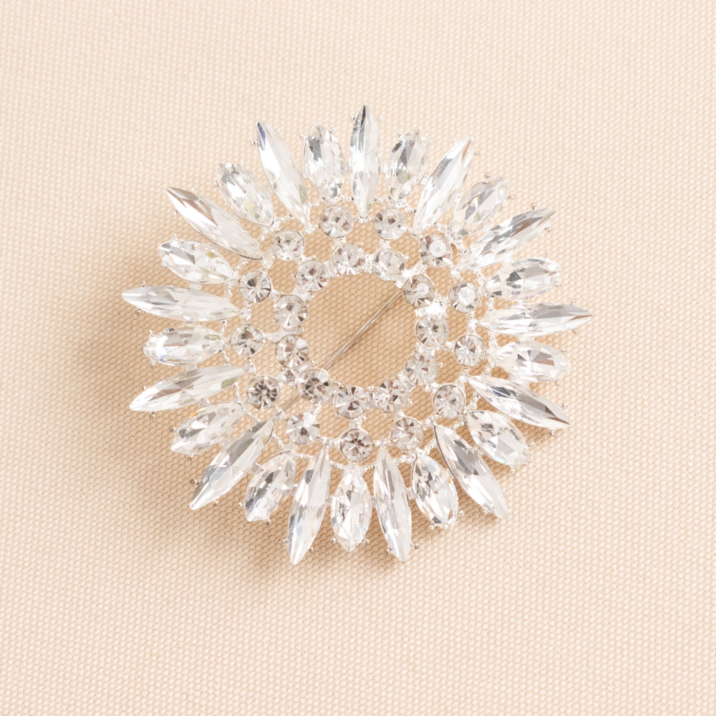 Silver metal snowflake brooch pin with diamonds and rhinestones.
