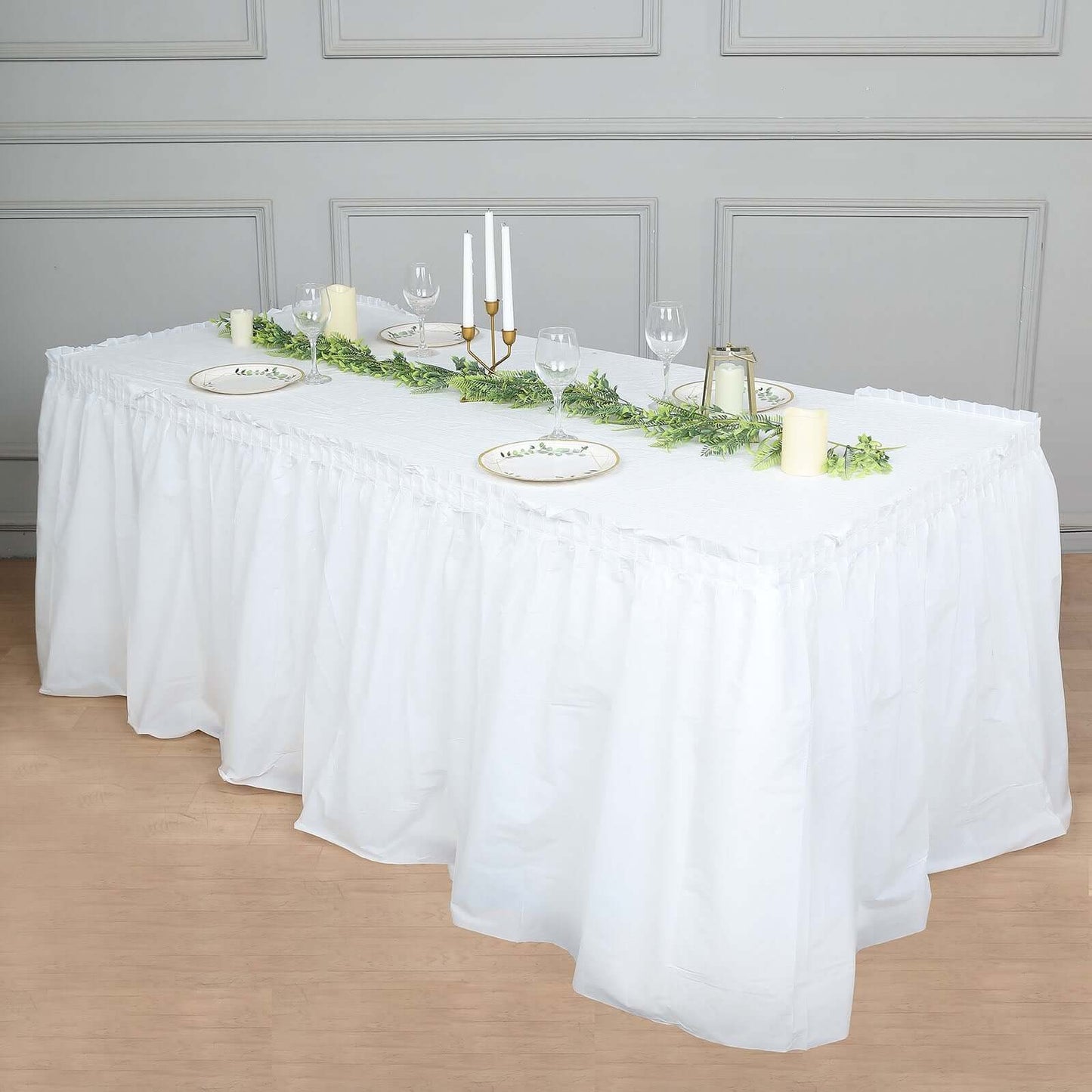 White ruffled plastic table skirt for events, 14ft long, durable and disposable.