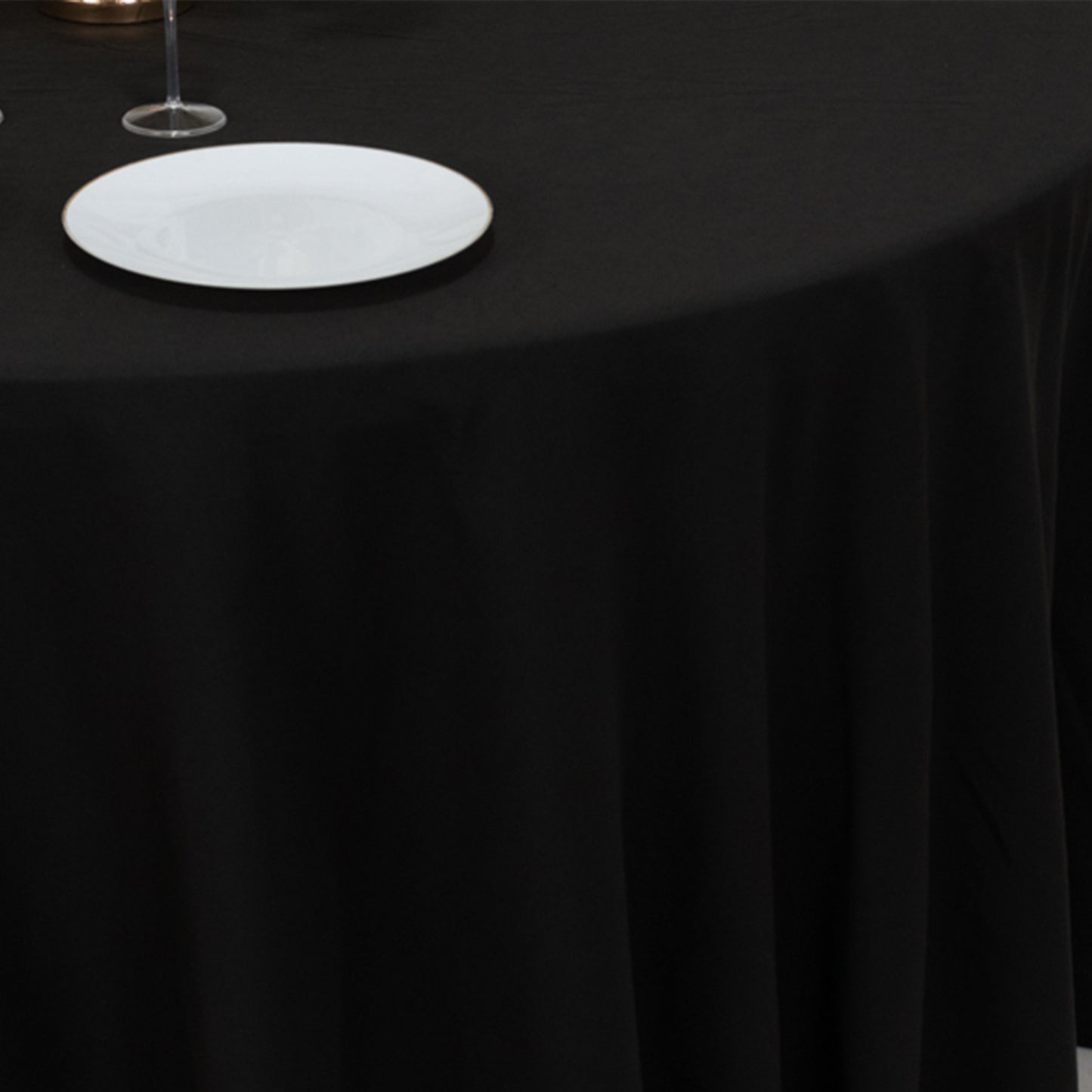 Black cotton blend round tablecloth for 5-foot table with floor-length drop.
