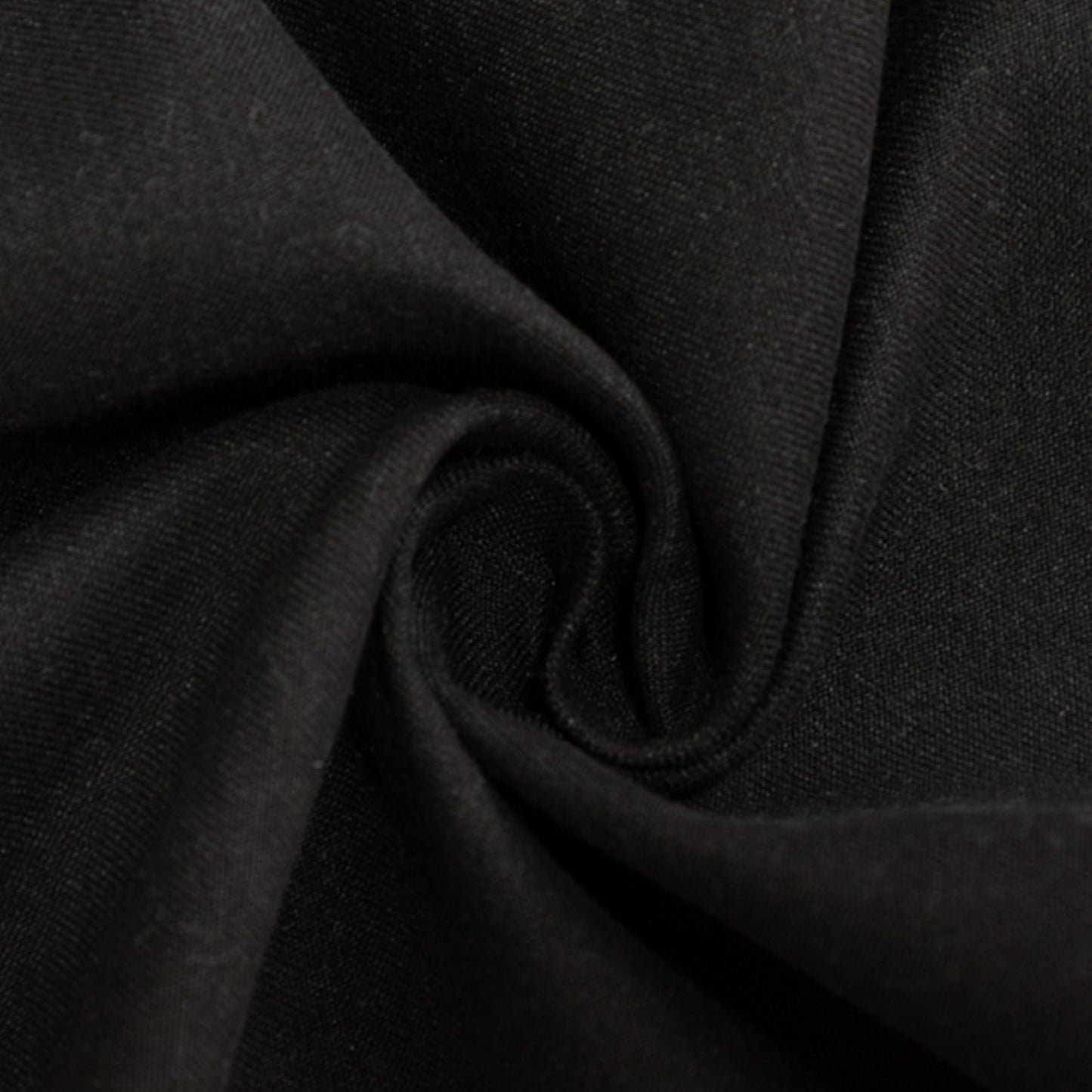 Black cotton blend round tablecloth fabric close-up.