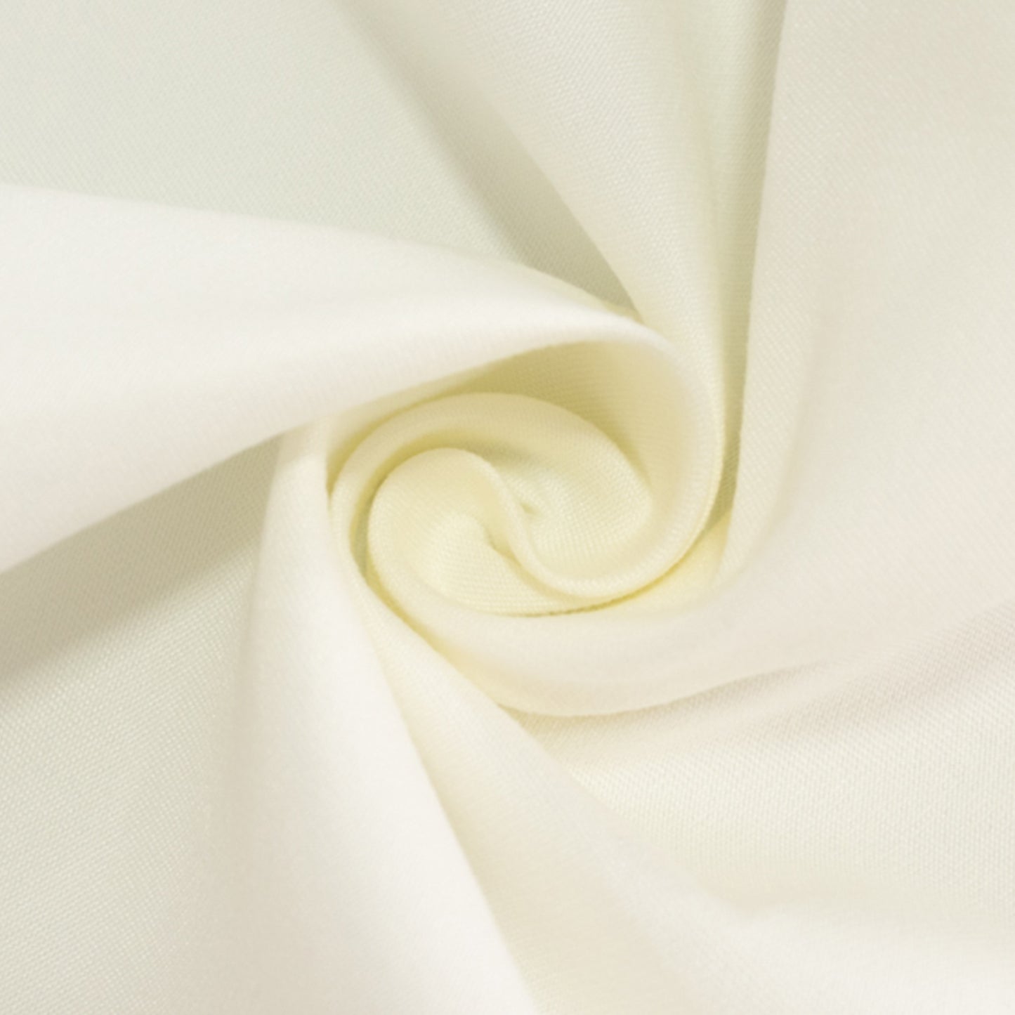 Ivory cotton blend round tablecloth in a spiral pattern.