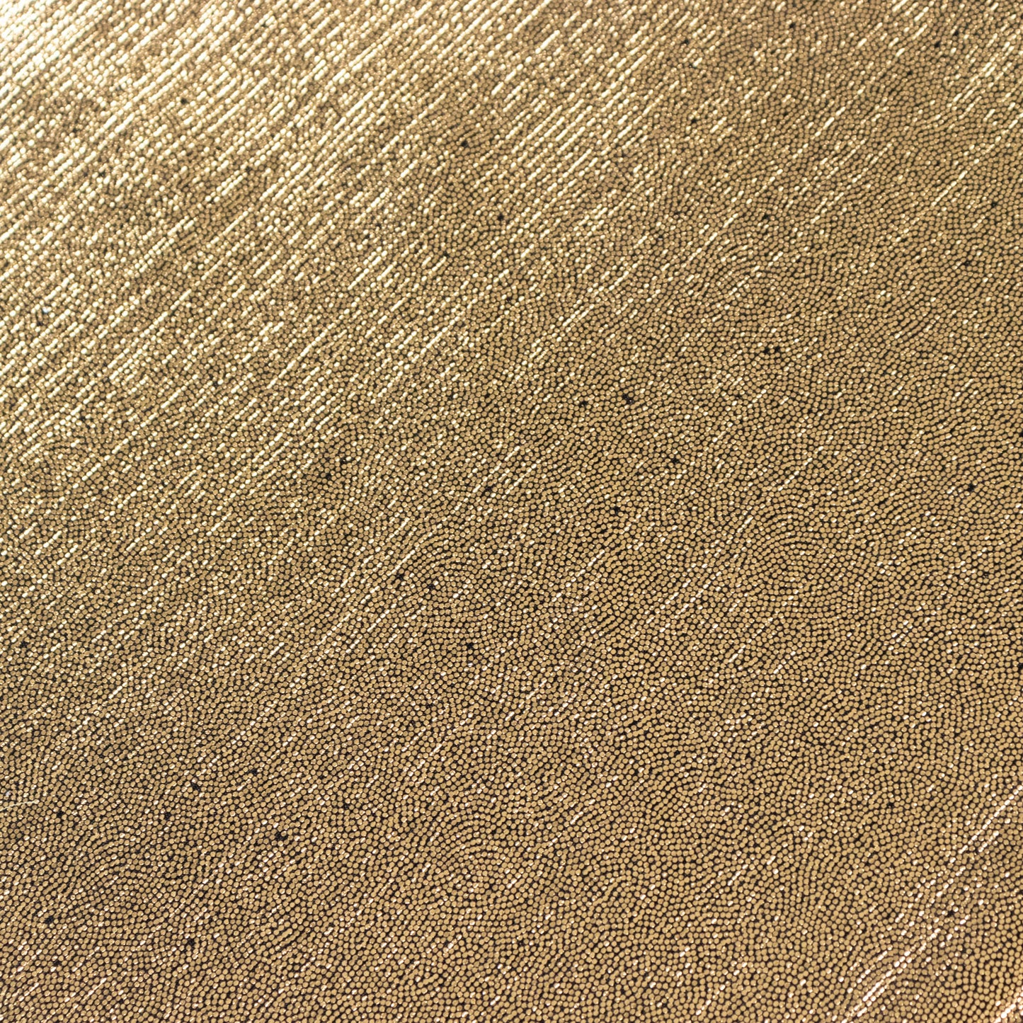 Shiny antique gold polyester tablecloth with sequin dots.