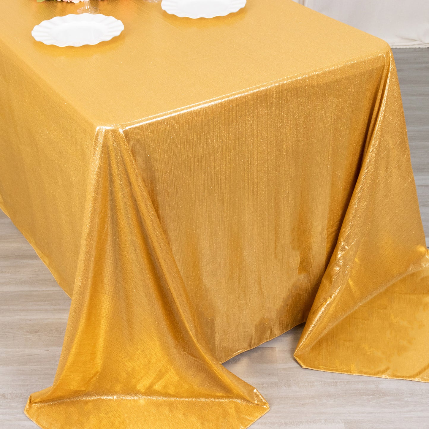 Gold shimmer sequin tablecloth, wrinkle-free glitter tablecover for festive occasions.