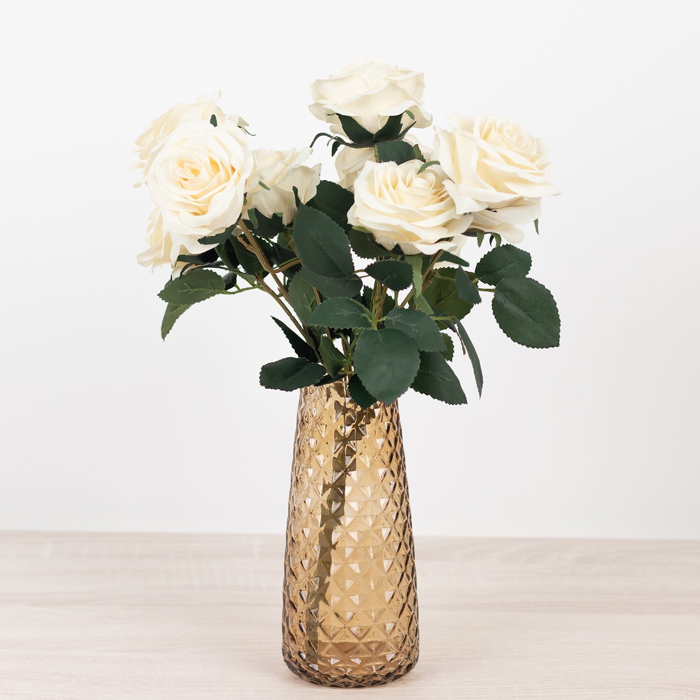 Amber gold crystal cut vase with white roses, perfect for centerpieces.