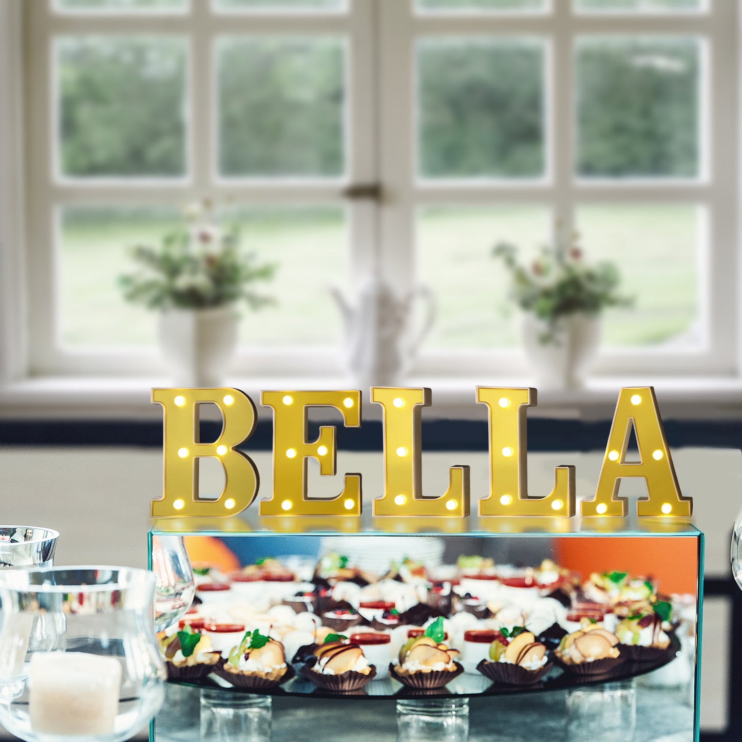 Gold 3D marquee letters "BELLA" lit up with warm white LEDs.