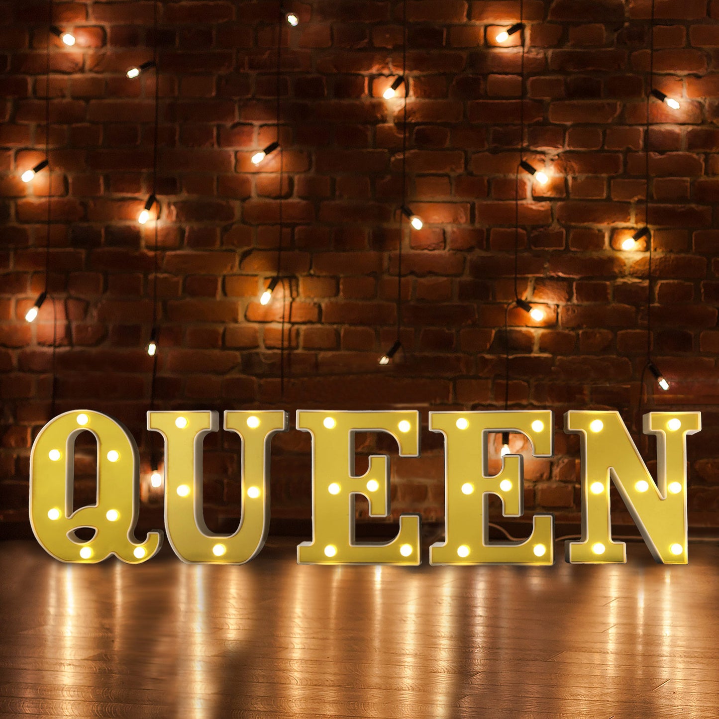 Gold 3D marquee letter "Q" with warm white LED lights.